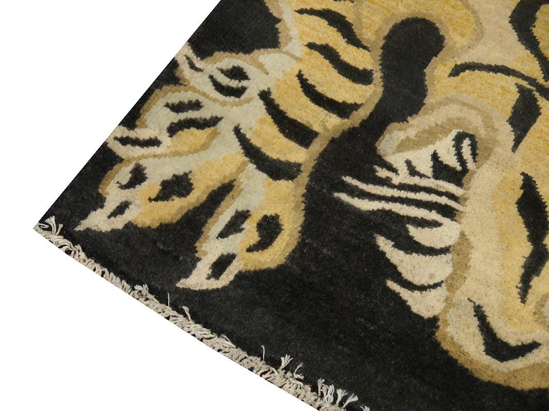 A Tiger rug, hand knotted in Afghanistan-
This traditional Tiger rug design is typically found on antique rugs called Khaden. It describes a small sized rug of about 3 x 6 ft that was used in Tibet to decorate columns or seat pad. Often these