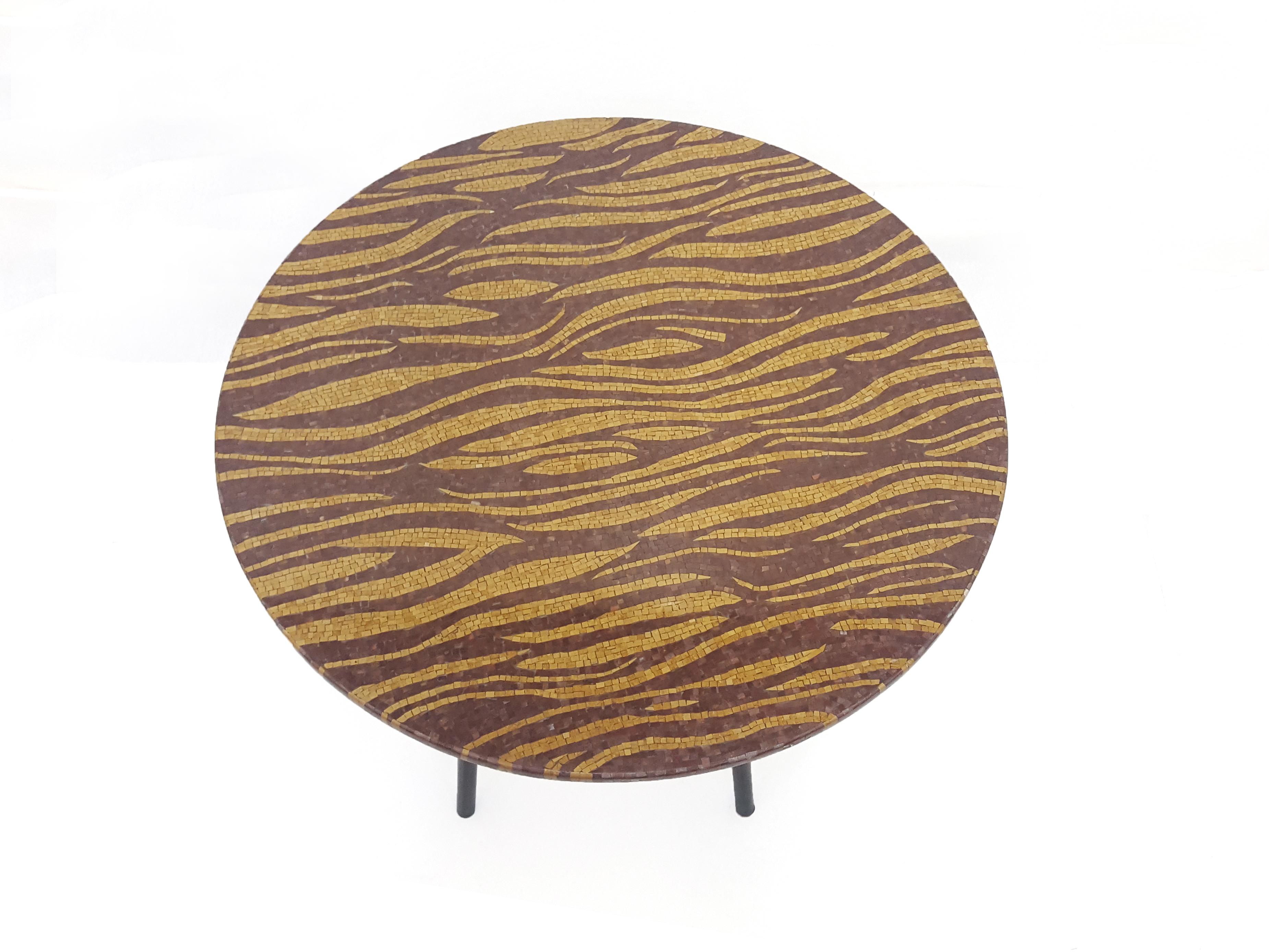 La table Tiger s'inspire de l'un des motifs de tapis les plus populaires de Stephanie Odegard. La table est fabriquée avec une mosaïque de pierres fines de haute qualité, composée de pierres semi-précieuses et fossiles. Chaque pièce de pierre mesure