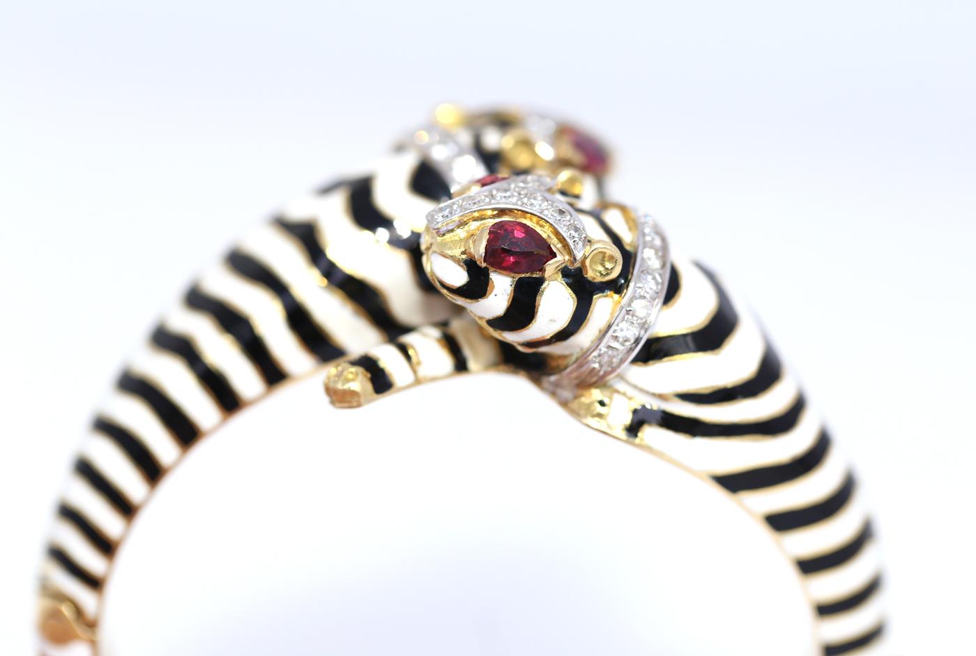 A tiger bracelet in zebra colours of Black White Enamel, fine Rubies depicting eyes. It is just such a 1960es item! So much colour and so much imagination infused in this fine bracelet. It is an attention-grabbing item whatever is the occasion. 

A