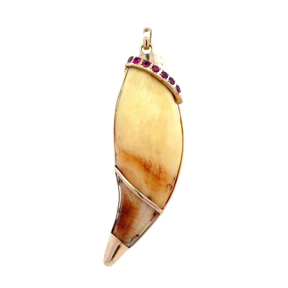 Simply Awesome! Featuring a Stylized Serpent Snake, Hand set with 1.05tcw Rubies. Finely Hand crafted in 14K Yellow Gold, wrapped around a Tiger's Claw. Pendant measures approx. 3.25