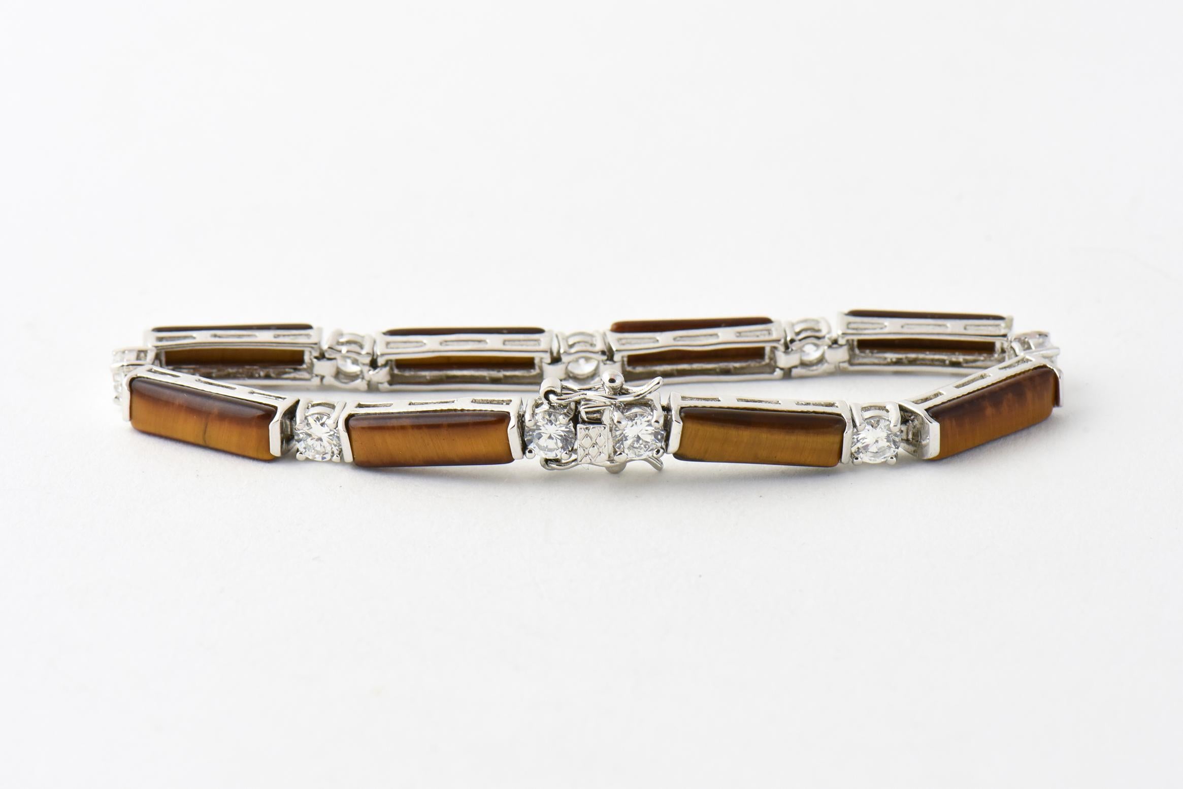 Sterling silver bracelet featuring tiger's-eye bars interspersed with cubic zirconias. Push clasp with safety. Marked: 925.