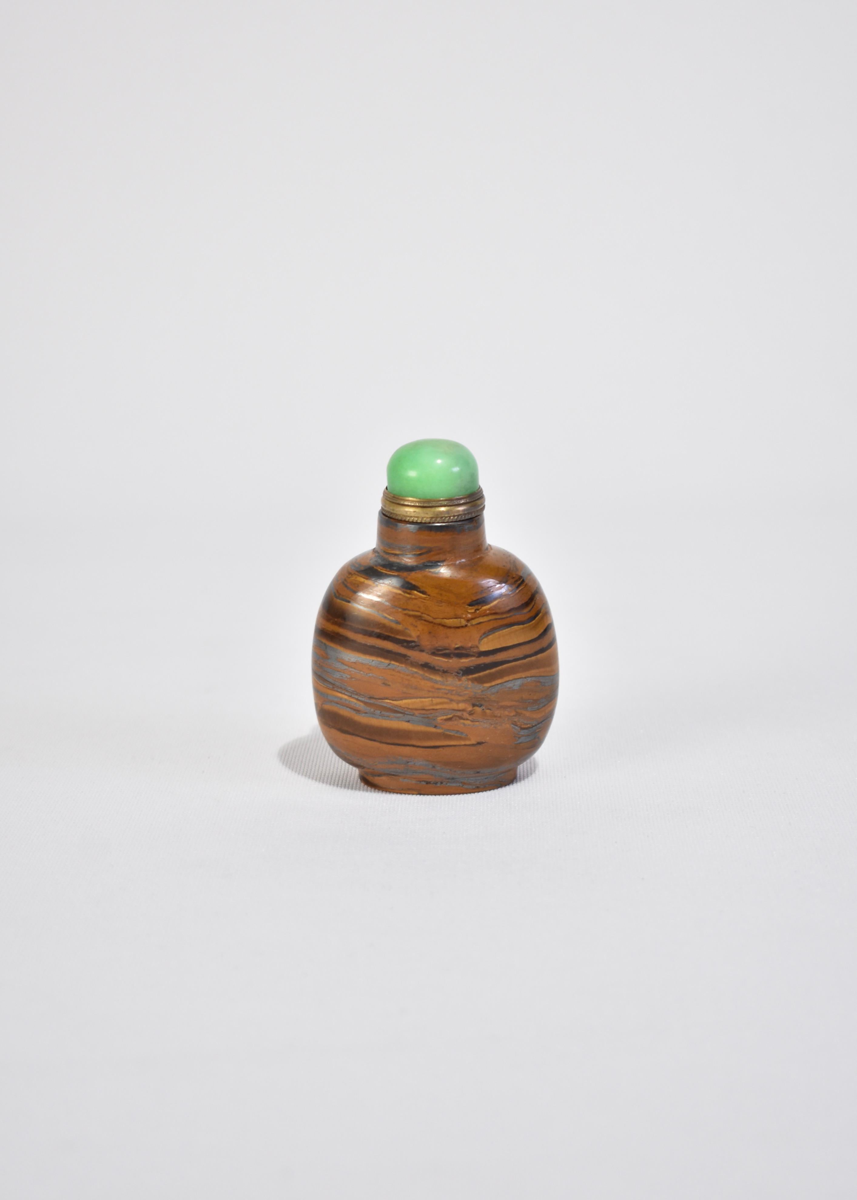 Stunning, vintage hand carved Chinese snuff bottle in Tiger's Eye with a Green Jade top. Display on its own as a decorative piece or fill with a favorite scent.