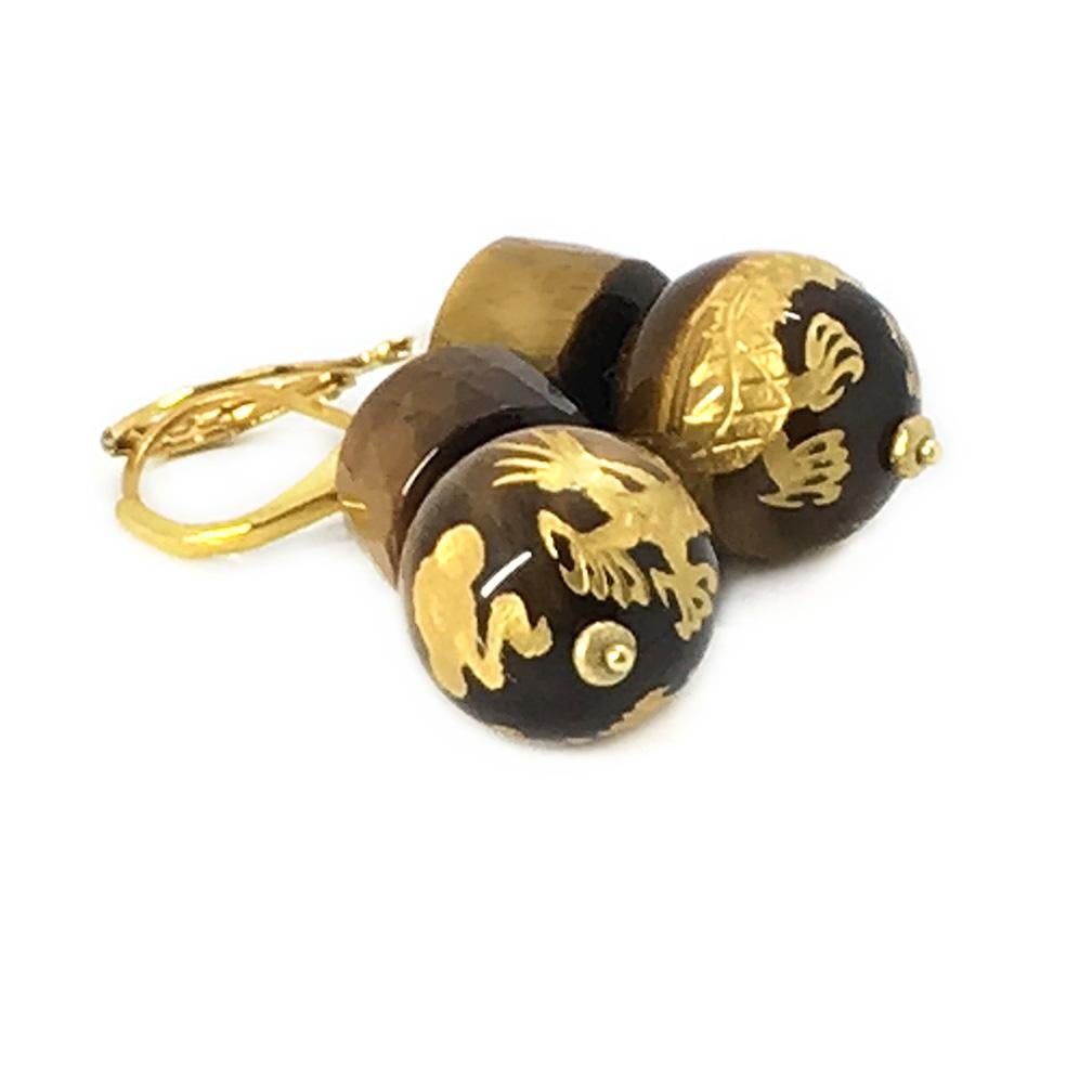 This is a pair of tiger's eye dragon earrings. There are carved golden dragons on 15mm tiger's eye spheres and 11 x 8 mm faceted drum shaped tiger's eye beads with brass lever-backs. Let's celebrate The Year of the Dragon!

Our vintage jewelry