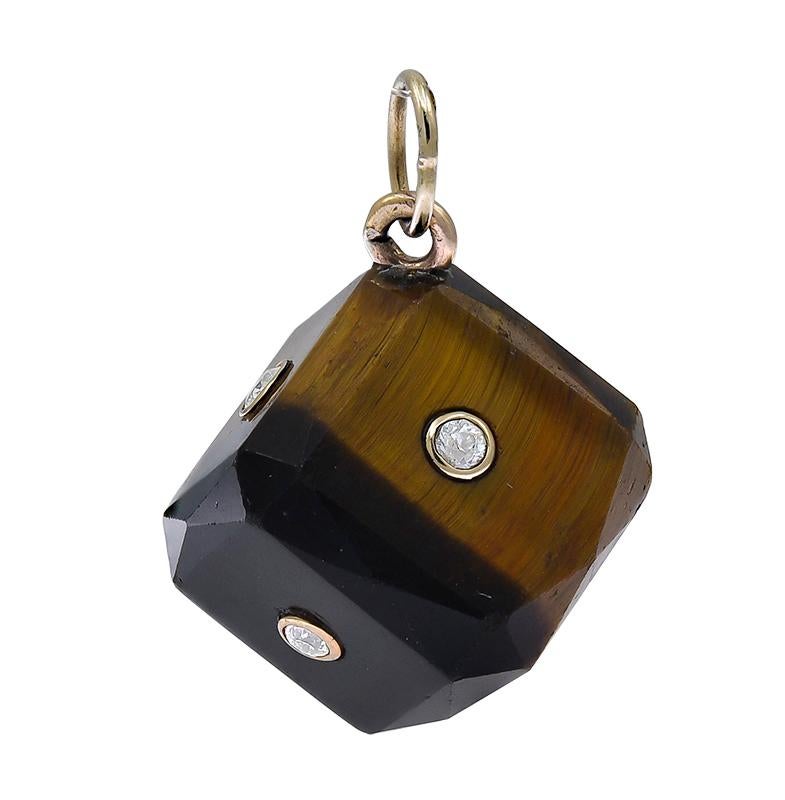 Unique figural 'dice' made of beveled tiger's eye.  Each side is set with a faceted diamond set within a gold bezel. 1/2