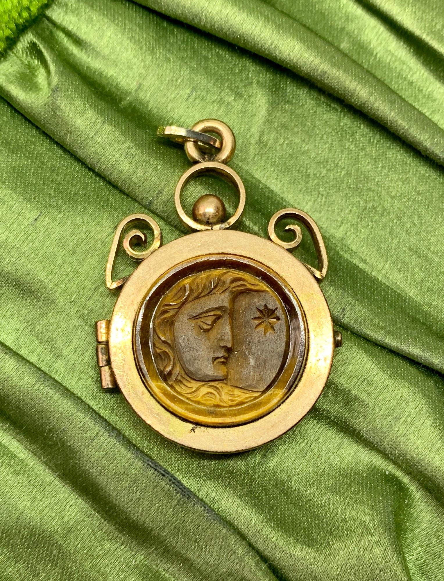 This is a rare and wonderful antique Belle Epoque, Victorian locket pendant with a beautiful hand carved Tiger's Eye gem with a fabulous image of a man in the moon with the sun or star.  This may be the god Apollo as well.  The radiant shimmering