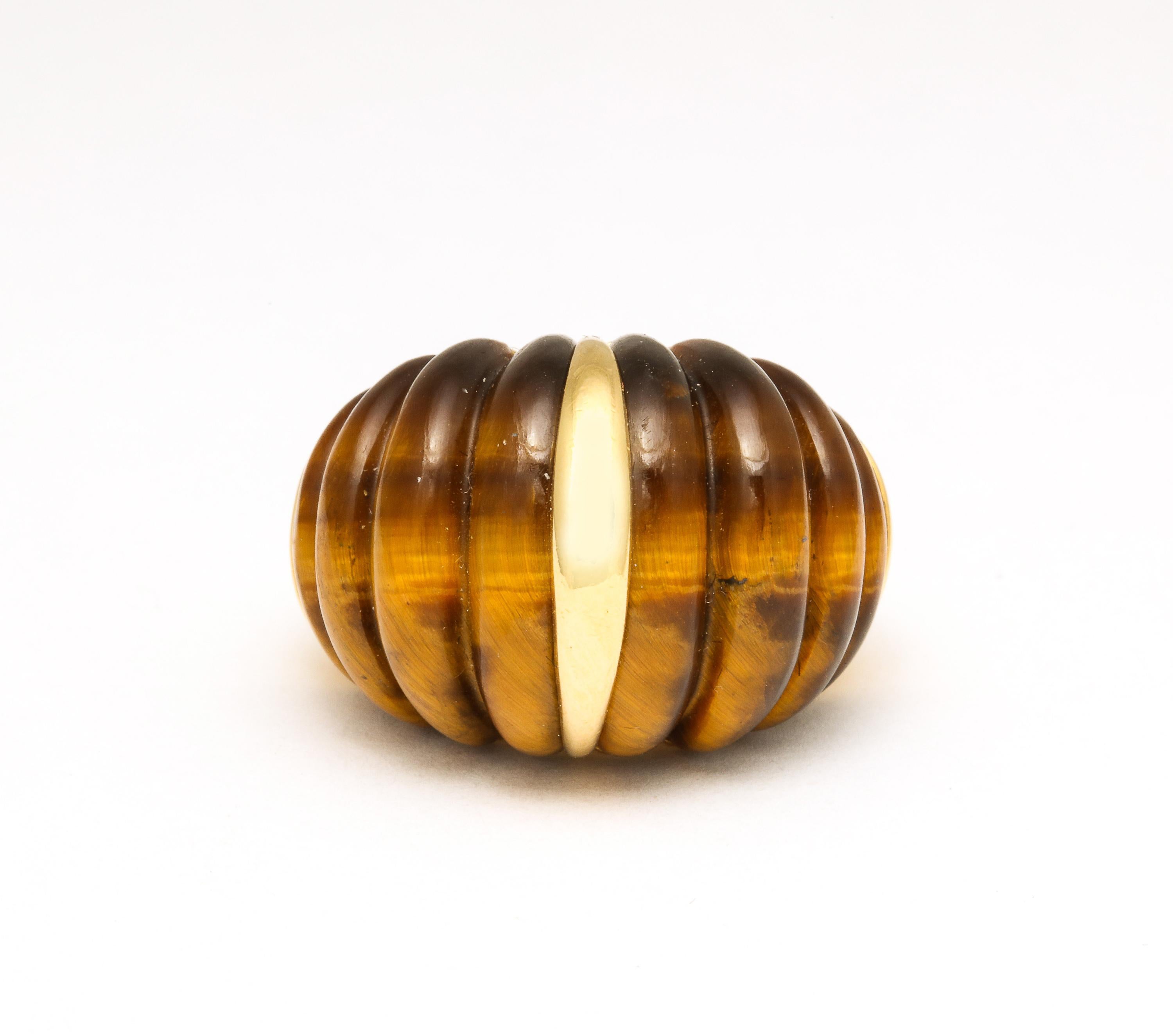 18kt  Yellow Gold and Melon Shaped Tiger's Eye Ring .  Very chic. Beautifully banded and ever so elegant and so much of the Period.

