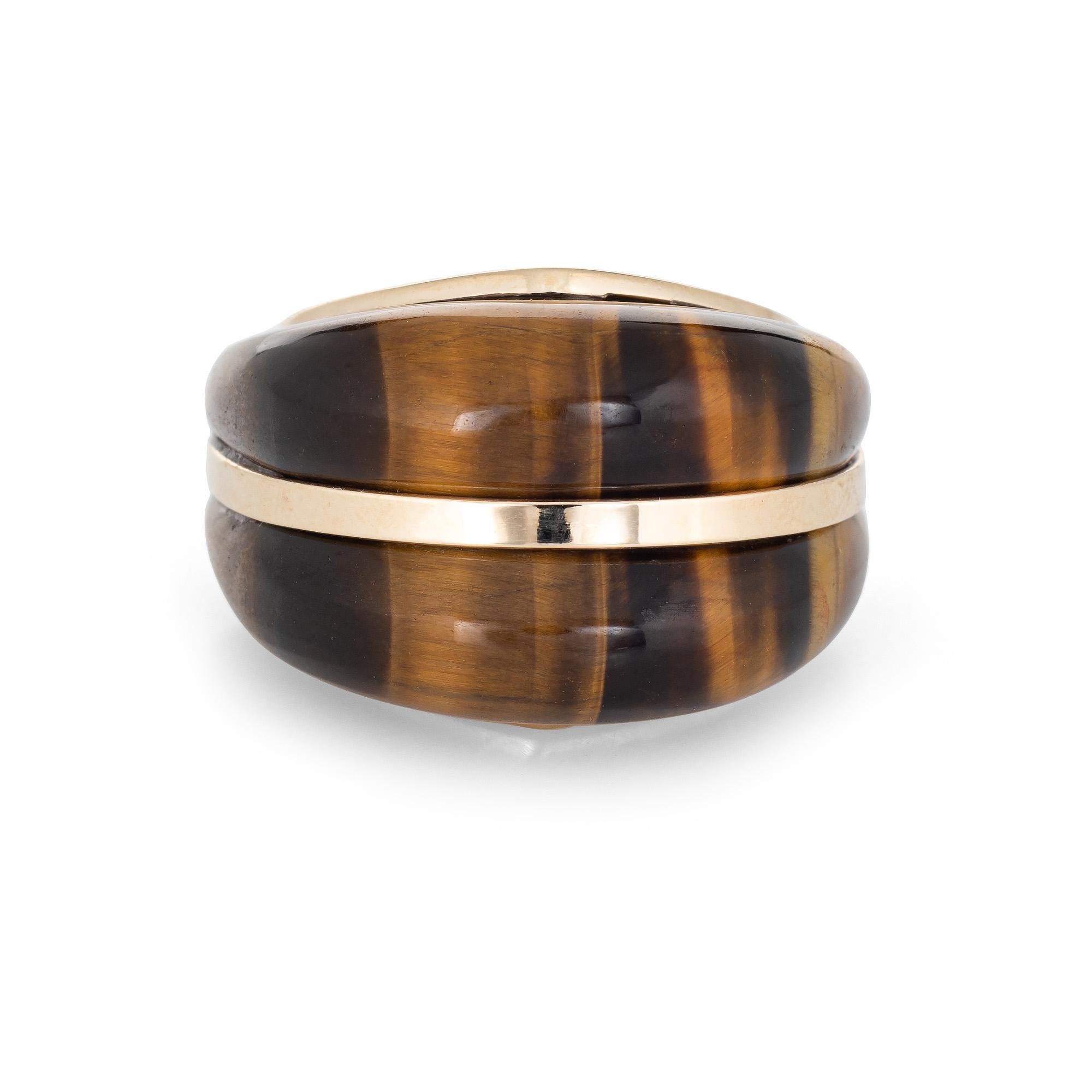 Finely detailed vintage tigers eye domed cocktail ring (circa 1970s) crafted in 14 karat yellow gold. 

Tigers eye measures 5mm side extending to the down to the side shoulders. The tigers eye is in excellent condition and free of cracks or chips.  