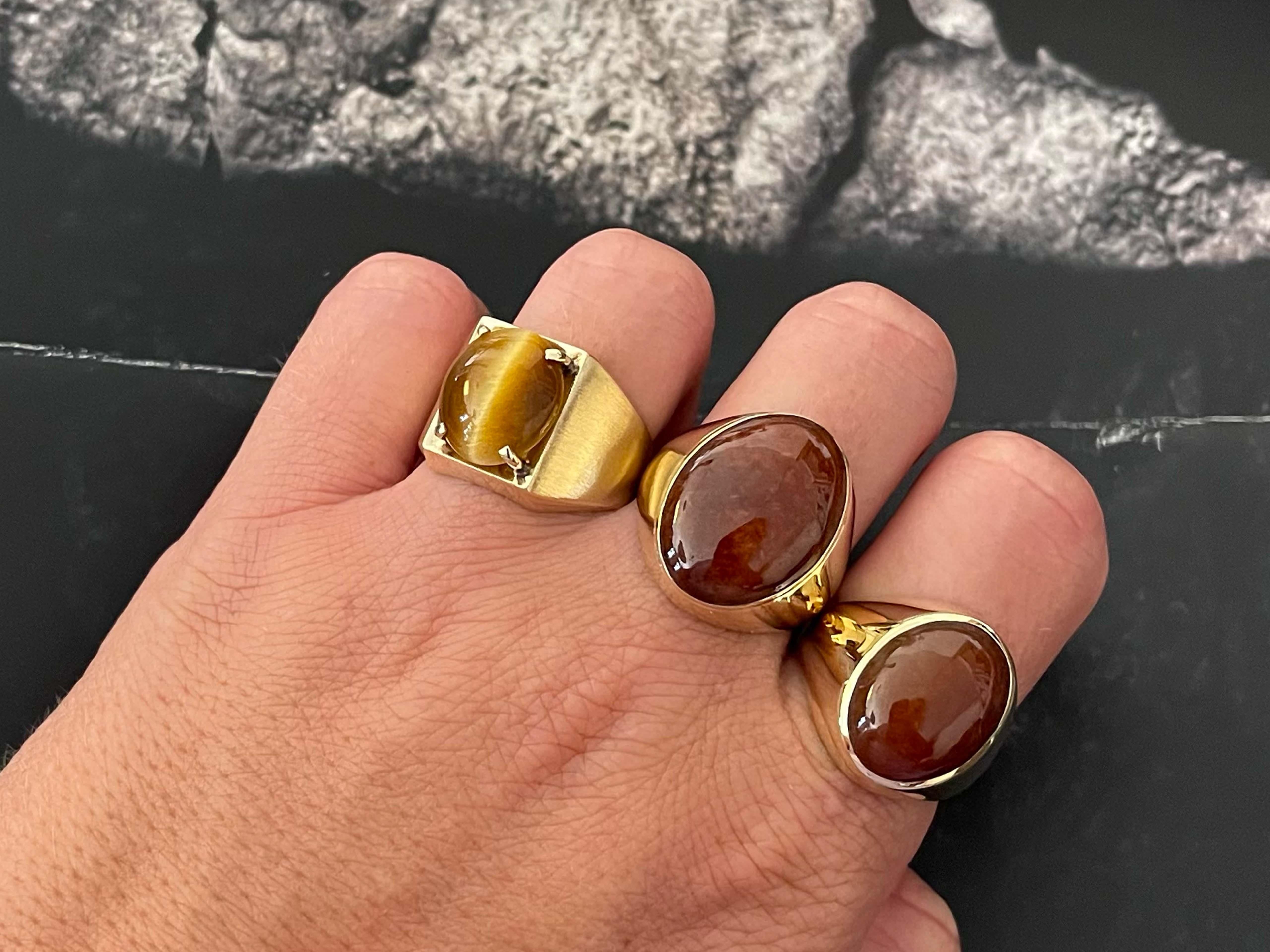 Ring Specifications:

Metal: 18k Yellow Gold

Total Weight: 11.5 Grams

Tiger's Eye Carat Weight: ~5.5 carats

Tiger's Eye Measurements: 13.9 mm x 11.8 mm x 4.6 mm

Ring Size: 9.5 (resizable)

Stamped: 