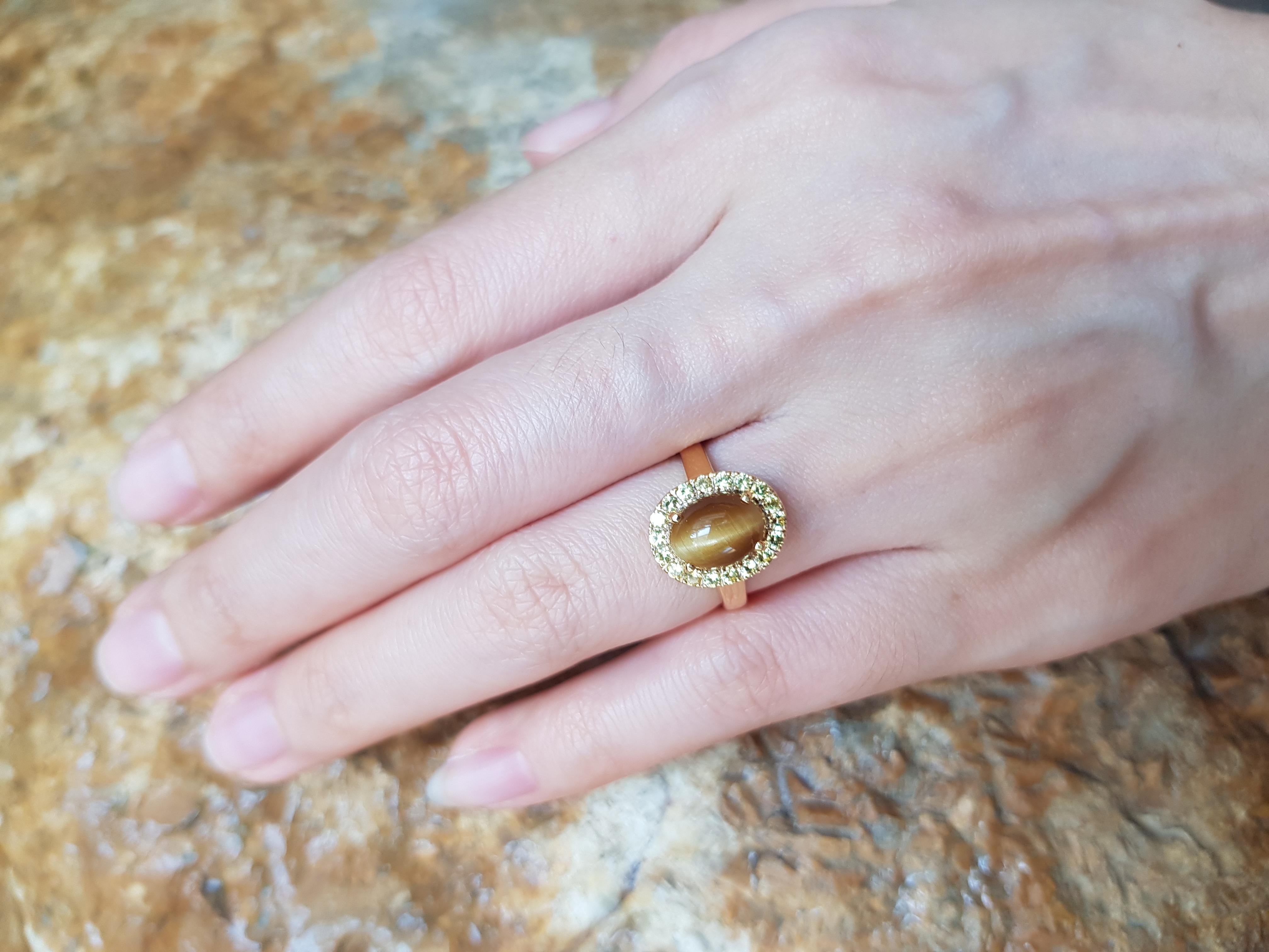 Tiger's Eye 1.18 carats with Yellow Sapphire 1.32 carat Ring set in 18 Karat Gold Settings

Width: 1.0 cm
Length: 1.3 cm 
Ring Size: 49

