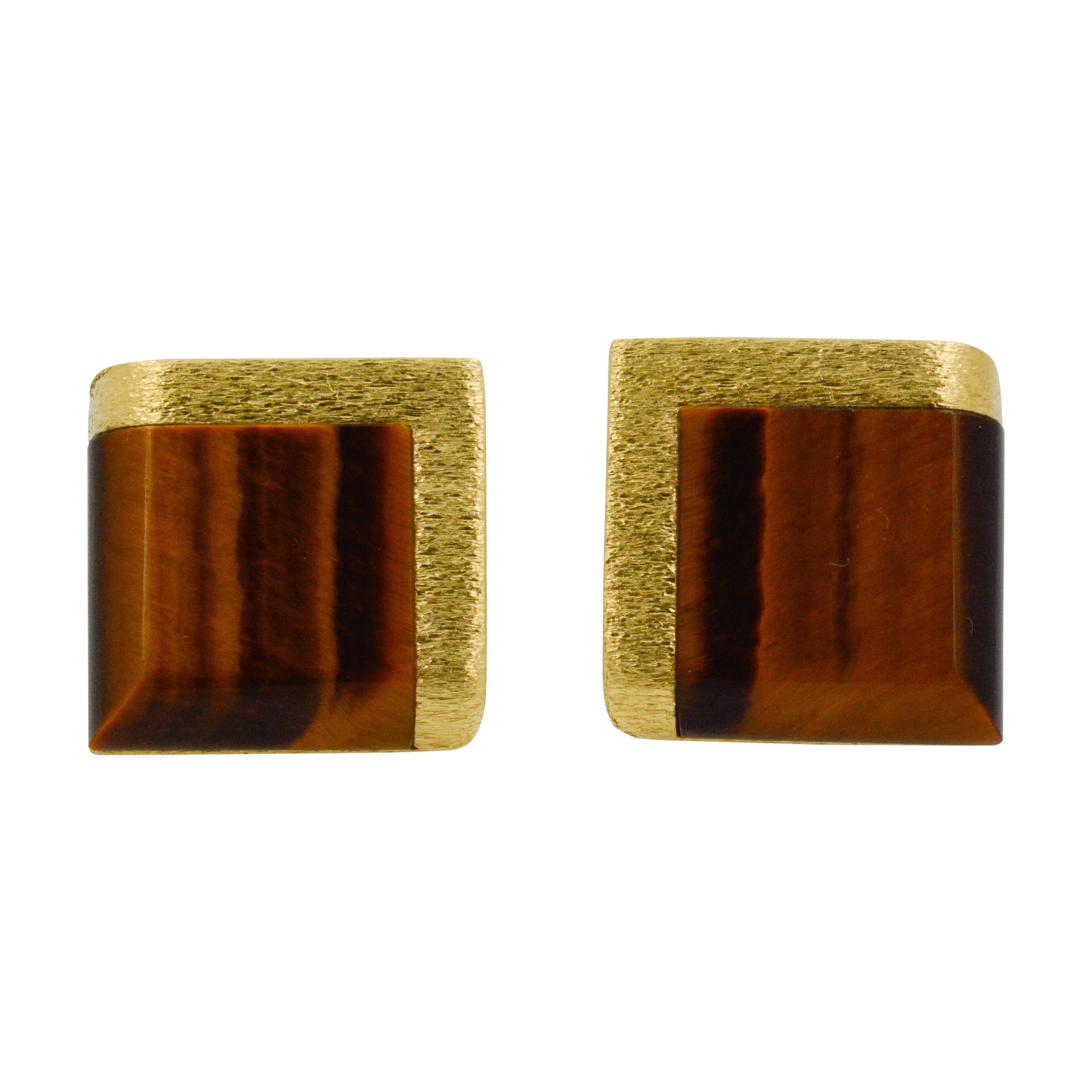 These charming square cufflinks are adorned with tigers eye and a matte 18k yellow gold bored on two sides. The rest of the cufflinks are in 18k yellow gold, creating a classic look perfectly paired for any look. 