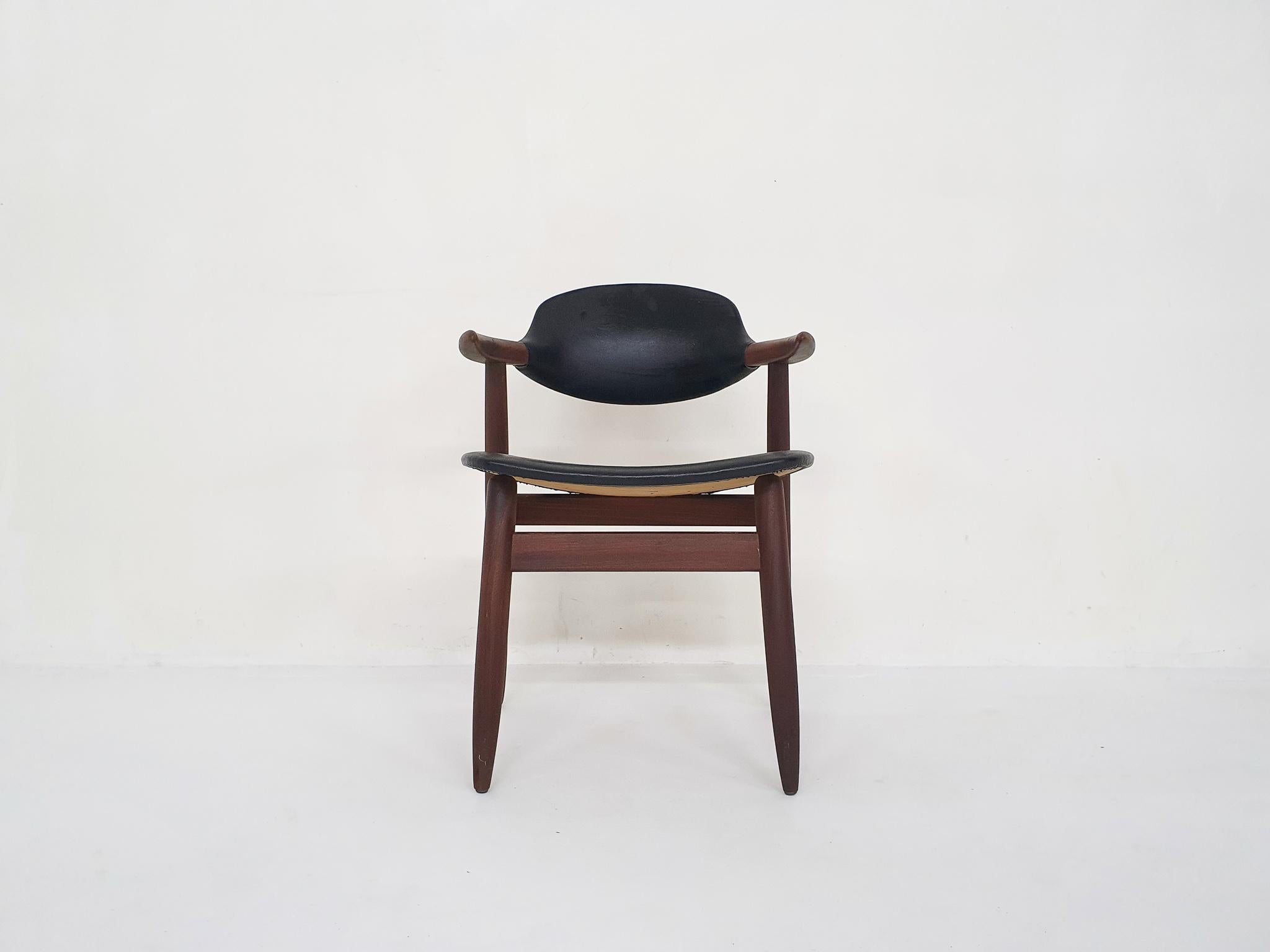 Teak dining chair with black vinyl upholstery. In good original condition.