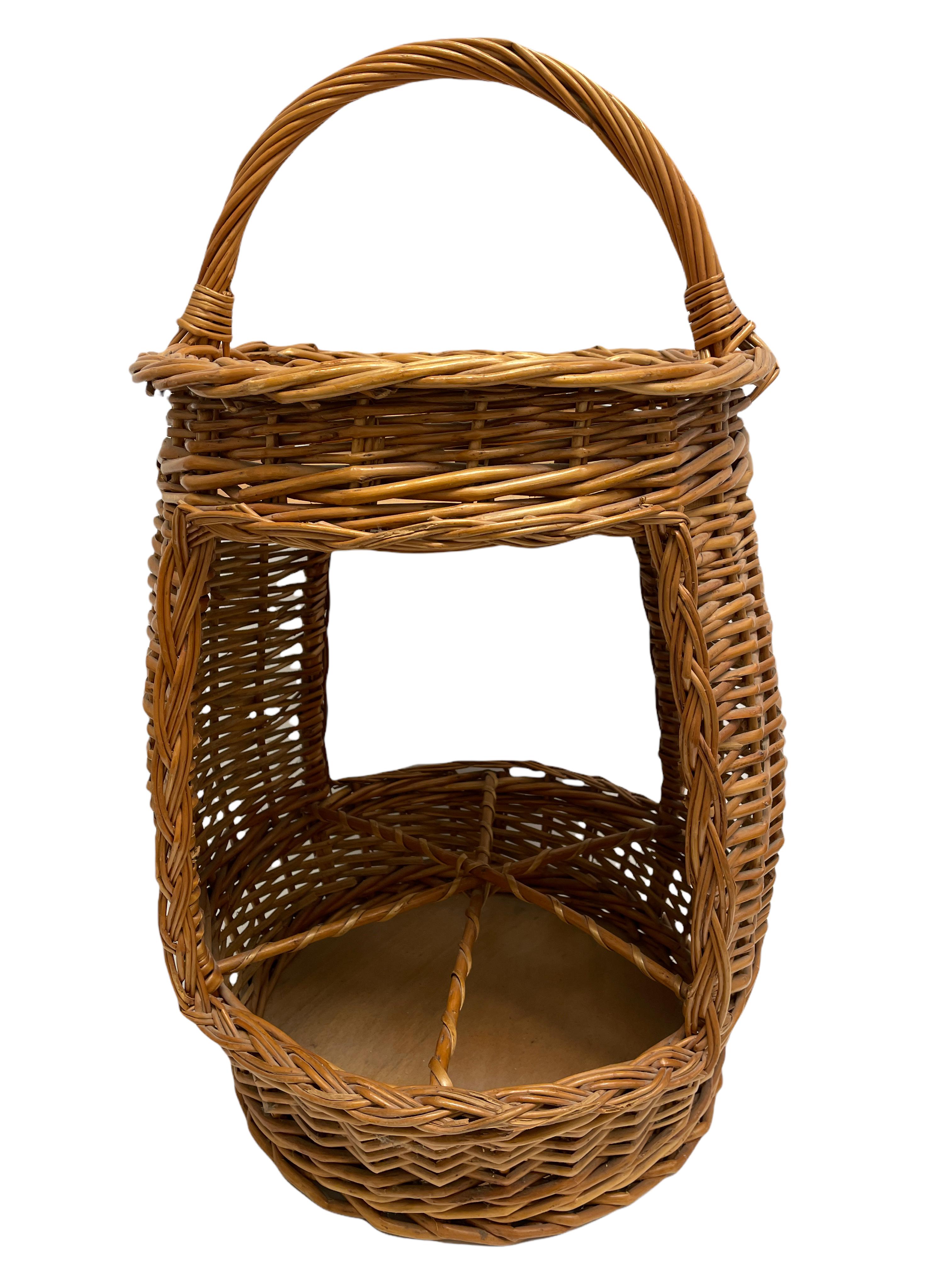 Mid-20th century eye-catching barrel shaped bar basket constructed in hand-braided rattan accented with wood. Nice addition to your home, patio or garden. This is in used condition, with signs of wear as expected with age and use. A nice addition to