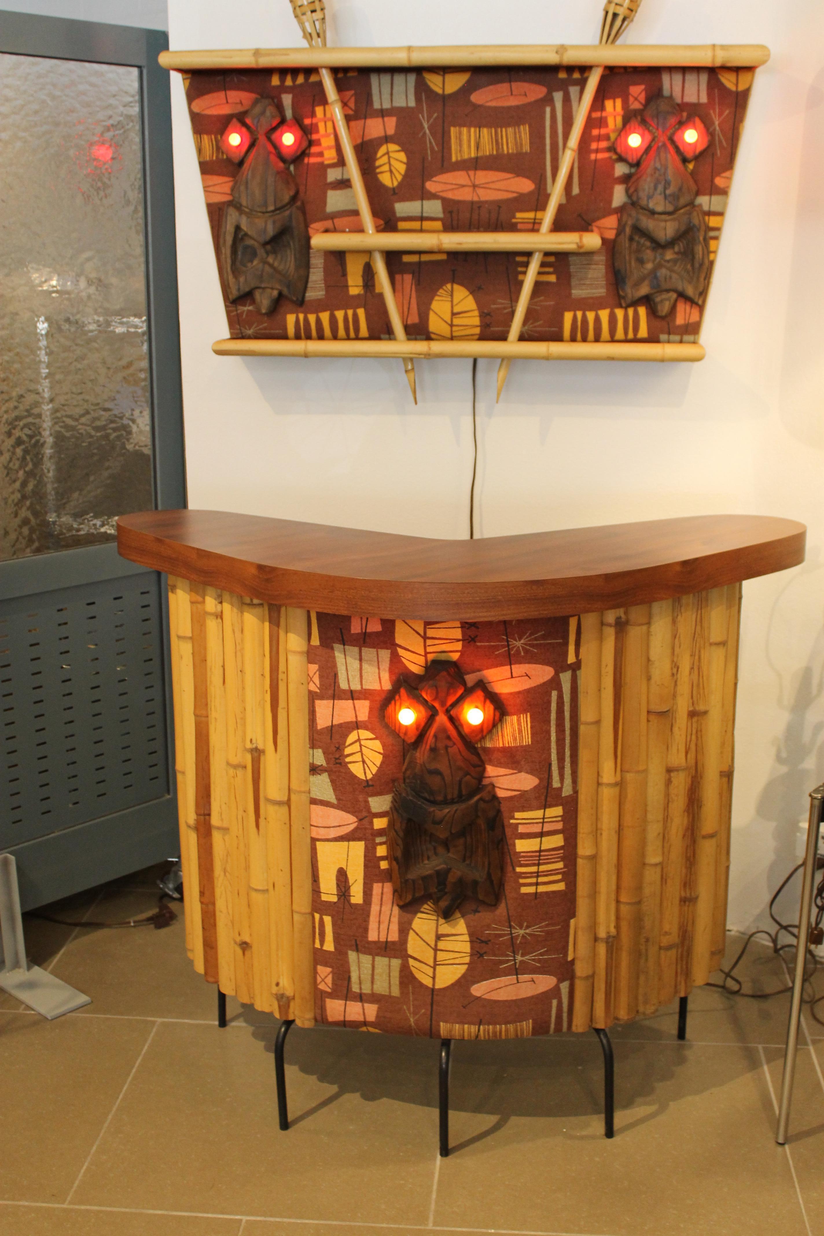 One of a kind studio made tiki bar with back bar and a pair of stools. Wood masks were created by Tiki Bosko Hrnjak about 20 years ago.   Bosko and his work have been featured in numerous books, newspaper and magazine articles.  Contains vintage