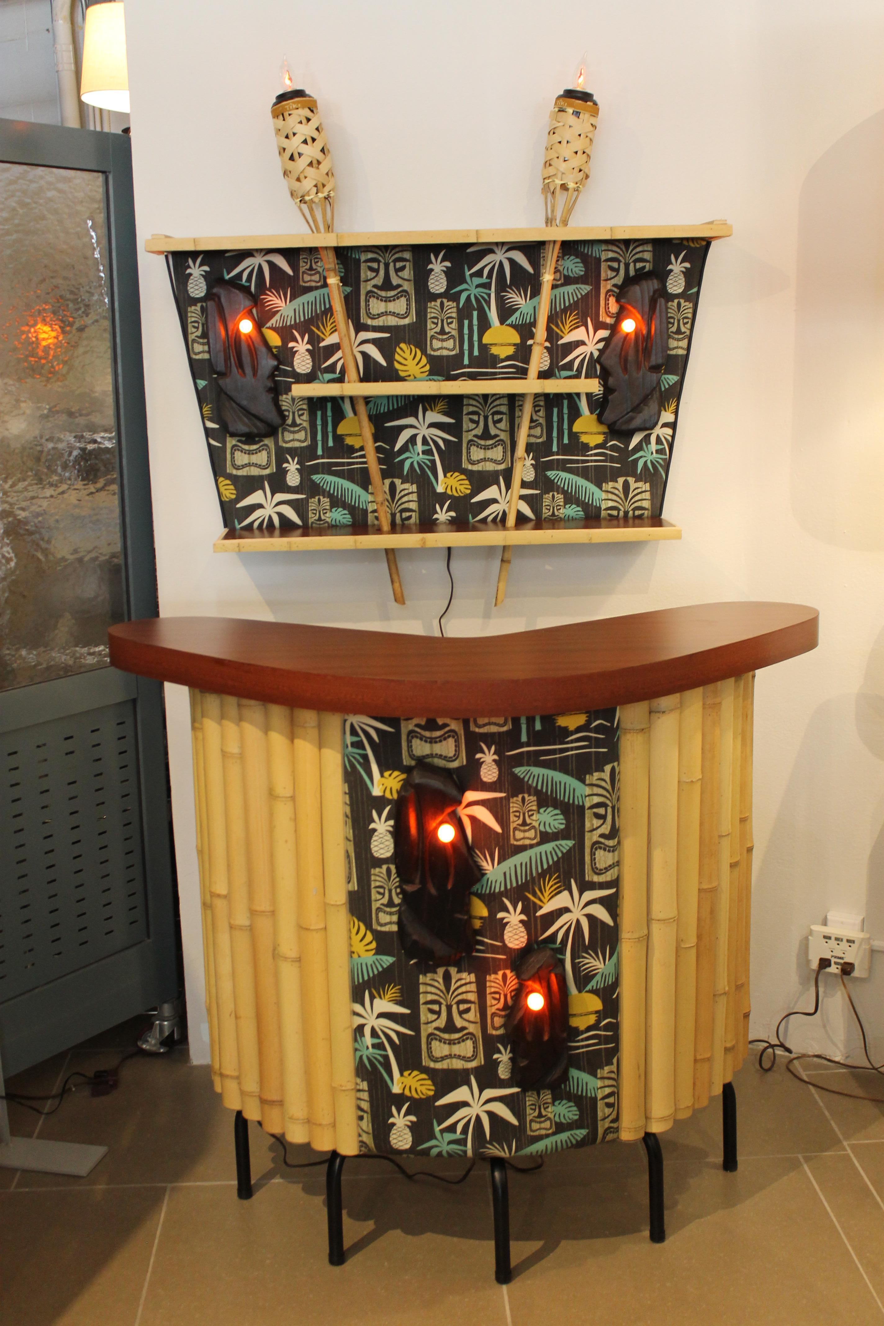 One of a kind studio made tiki bar with back bar and a pair of bar stools. Contains new heavy canvas fabric in vintage style. 
Bar measures: 50