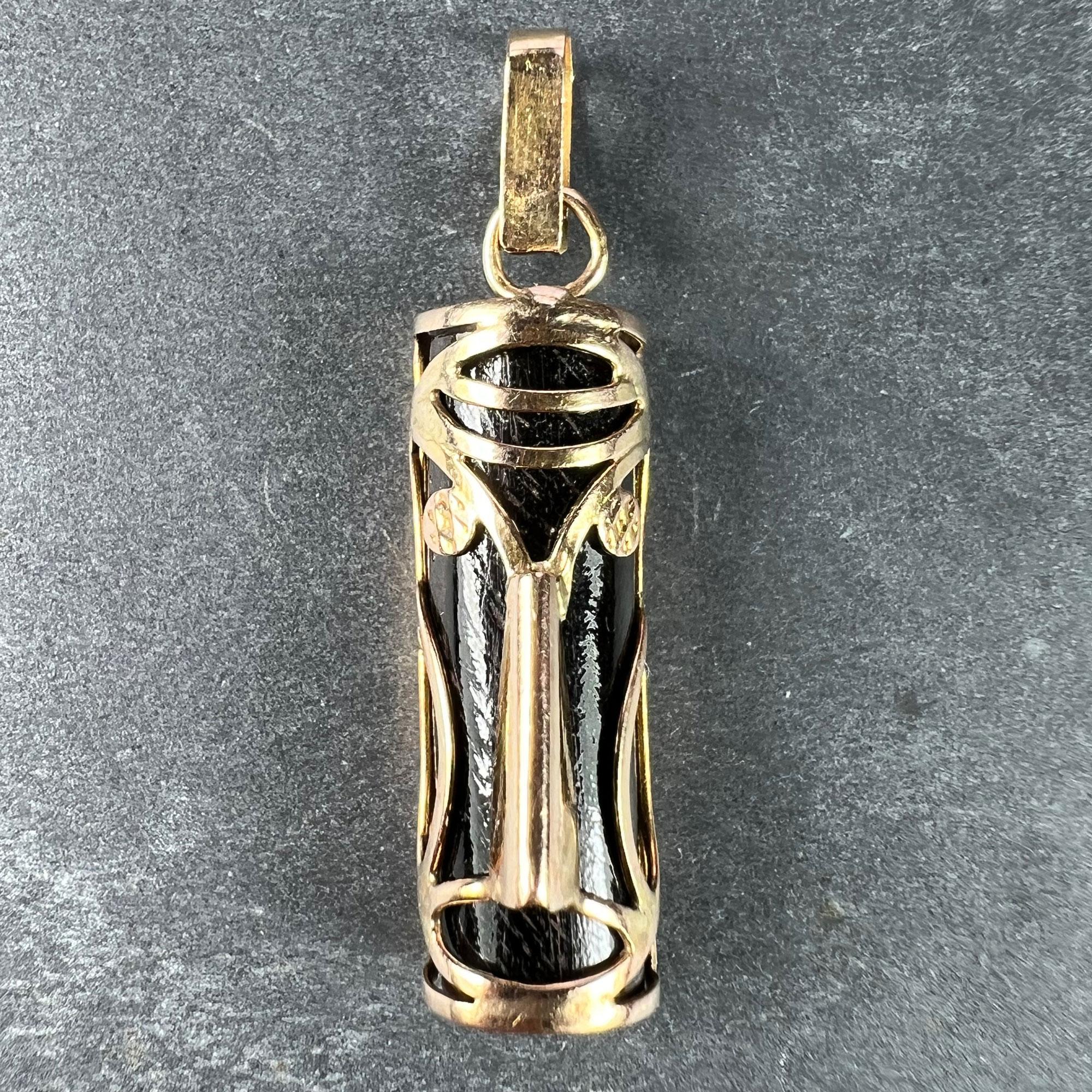 A 14 karat (14K) rose gold and dark wood lucky charm pendant designed as a Hawaiian or Maori Tiki mask in rose gold wire over a half-cylinder of dark wood for the good luck aspect of the Touch Wood theme. Unmarked but tested for 14 karat gold.