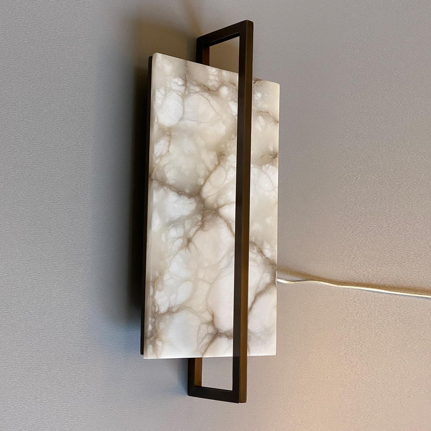 A truly stunning combination of contemporary lighting design and classic Italian stone craftsmanship, this splendid Tile Sconce is a distinctive piece for any contemporary or traditional interior. The sconce features an elegant vertical rectangle in