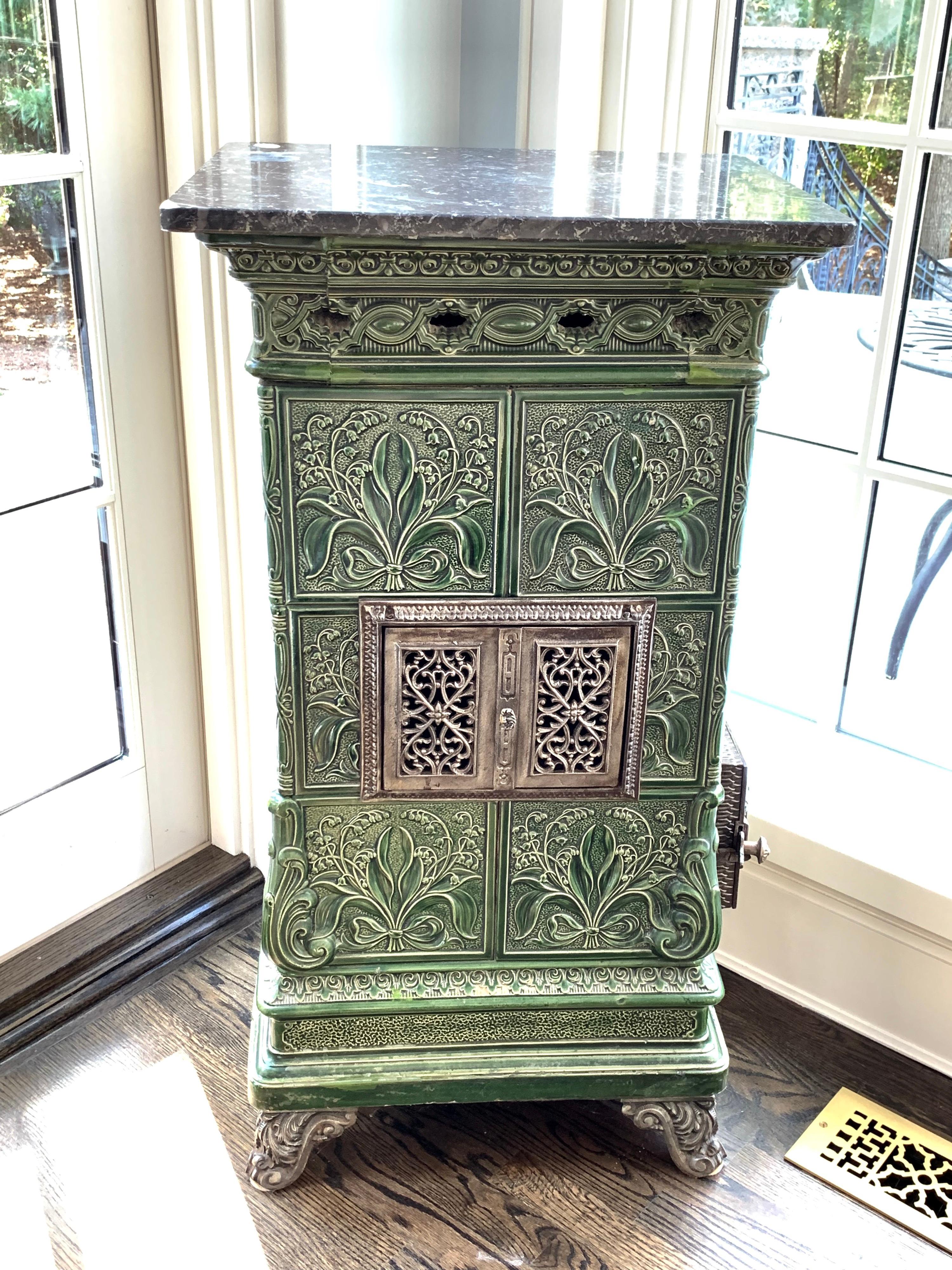 This beautiful French Majolica Tile Stove is from circa 1910-1920. The Tiles depict Lillies of The Valley in relief.