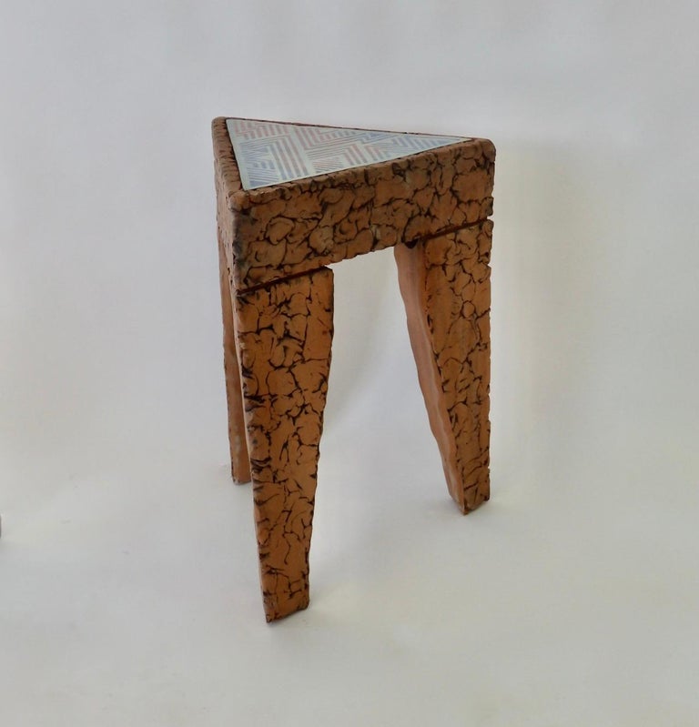 Michigan studio artist made terracotta brutal style side table. Triangle in form with tile top.