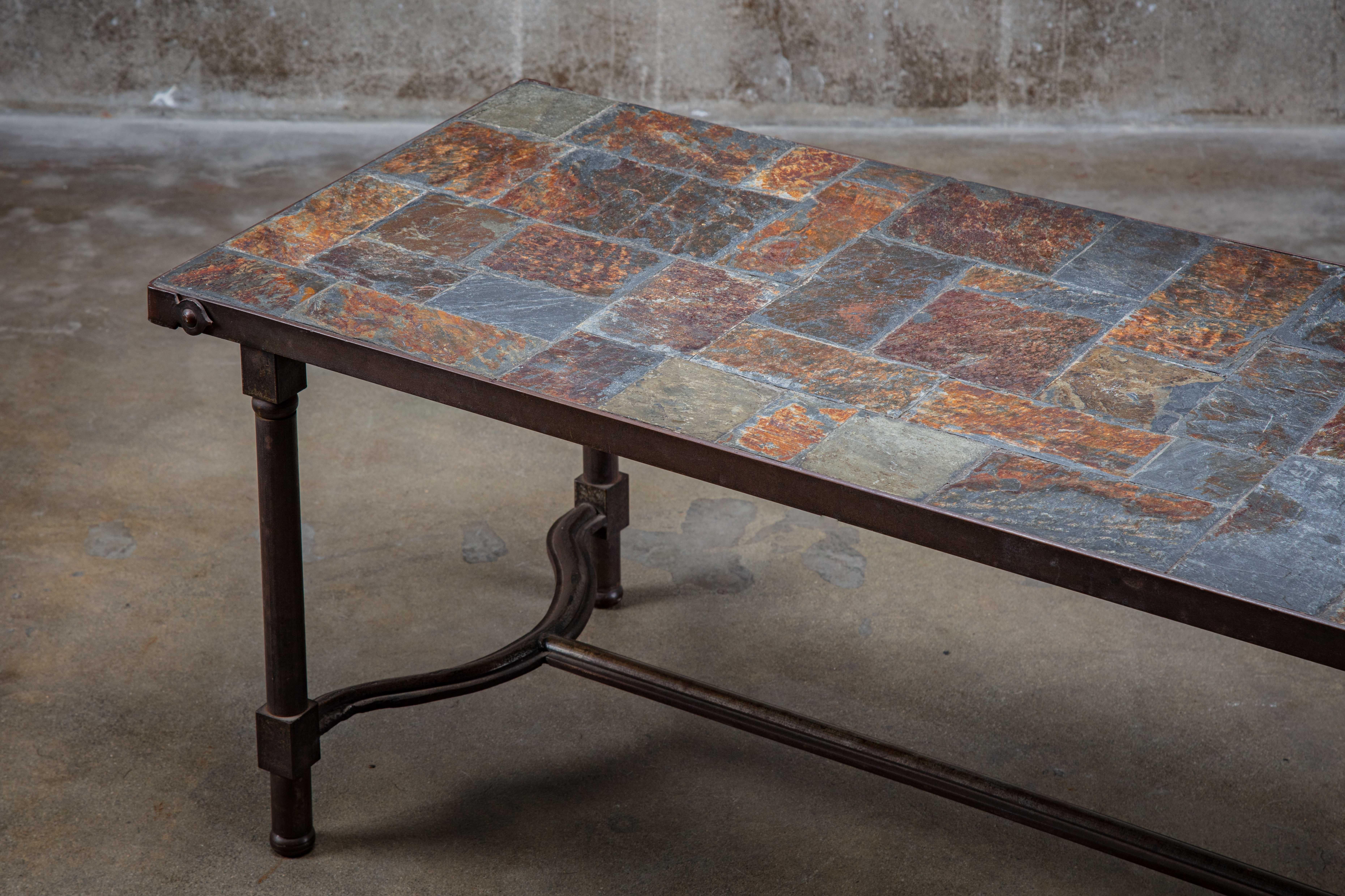 Iron and slate tile top coffee table in the style of Jacques Adnet, French, 1960s.