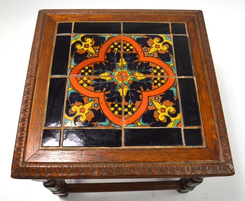 Wonderful tile-top stand with carved oak base. California made, probably either Catalina or Taylor Tilery - excellent original condition, shows only minor cosmetic wear to finish, normal and consistent with age. Hard to find period examples of