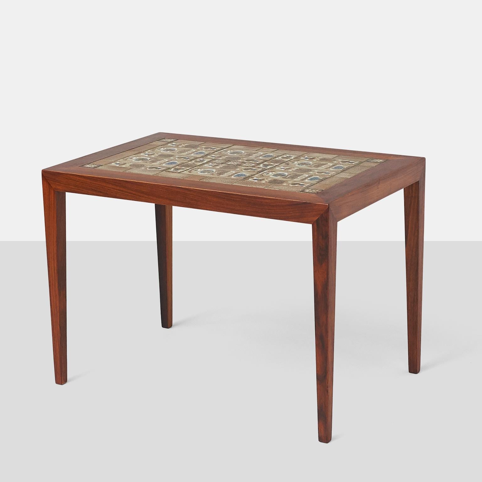 An end table in rosewood with inset ceramic tiles. Manufactured by Haslev Mobelfabrik, the tables were designed by Severin Hansen Jr and the tiles by Nils Thorsson.