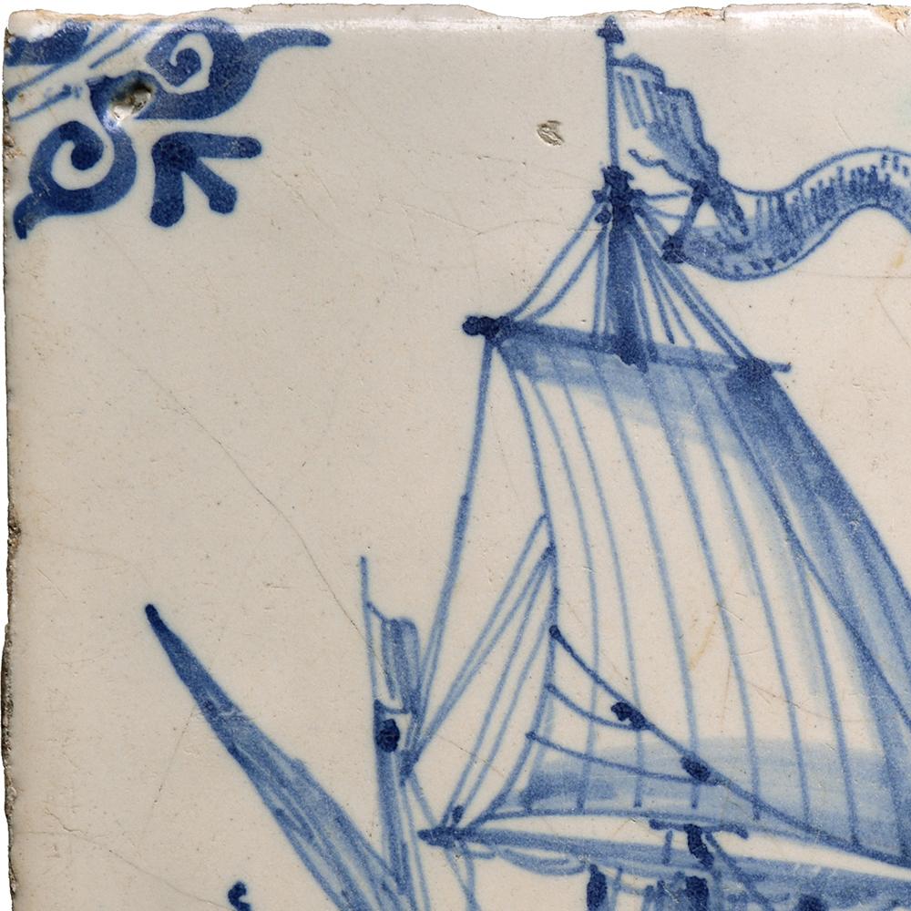 Three-master sailing to the right, three men visible. Corners decorated with motif.