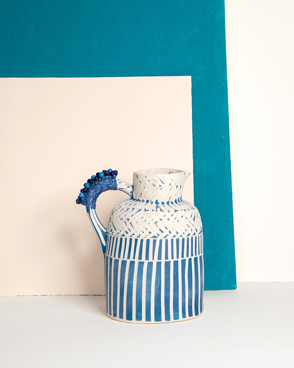A handmade jug to display in your kitchen
This navy blue Tiled Handmade Ceramic Jug is the perfect addition to your kitchen, dining room, or any party! This whimsical pitcher is rustic, colorful, and ready to party! Its unique blue and striped