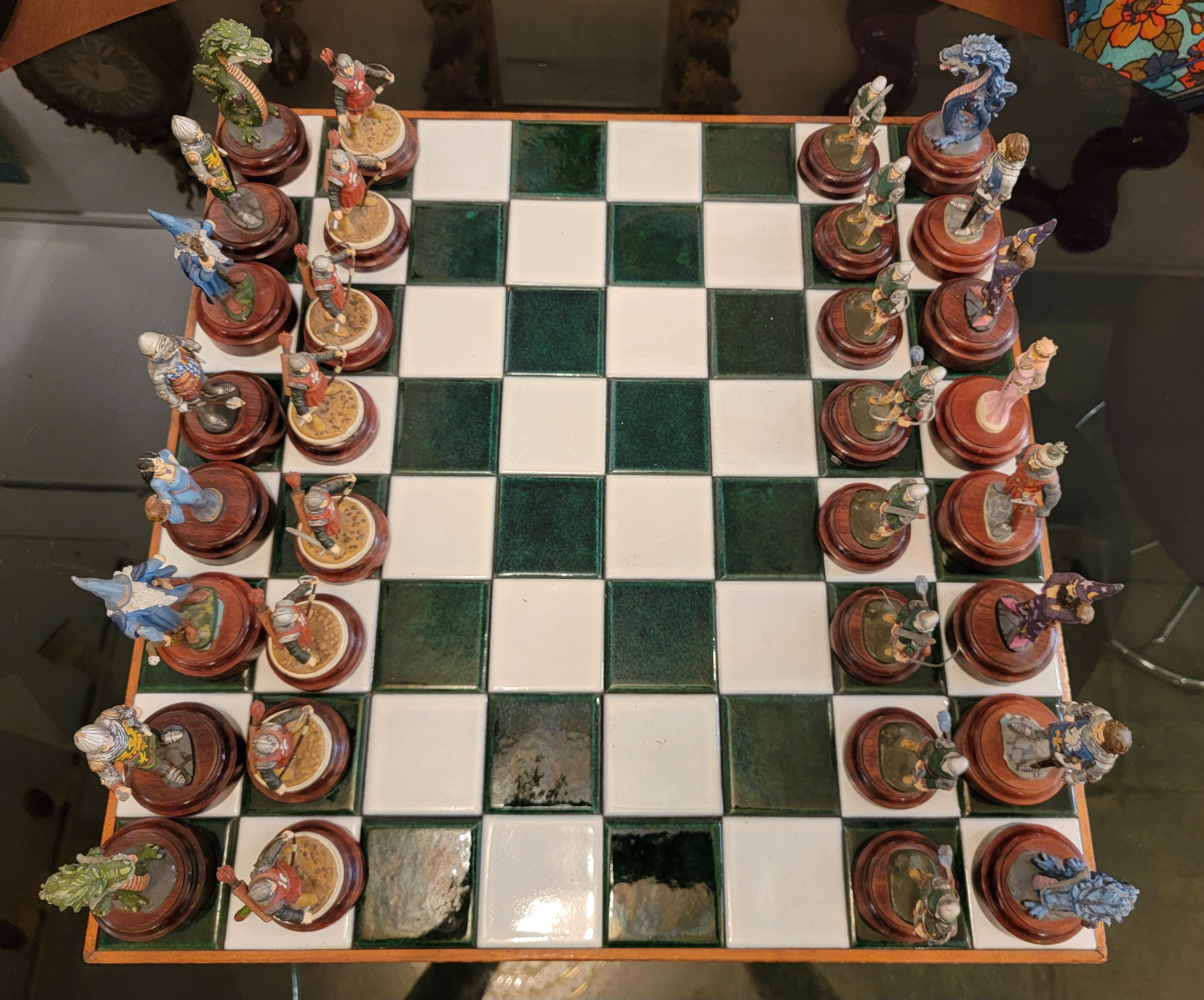 Tiled Mid Century and Wood Chess Board with Chess Figurines. Green and White tiles throughout. Each chess piece is placed above a wooden stand. Each piece is hand painted. There are 2 missing arrows that go to the back of the blue pawns. Paint is
