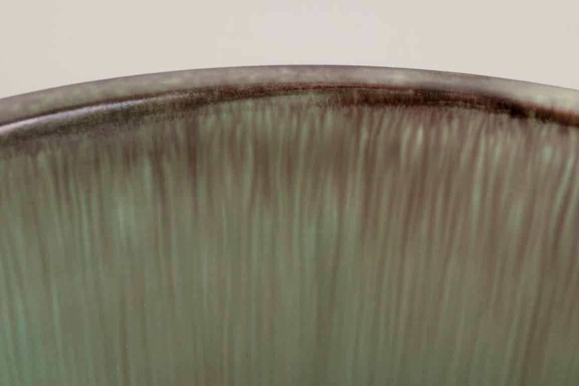 Swedish Tilgmans Keramik. Ceramic bowl on a foot. Glaze in green tones. For Sale