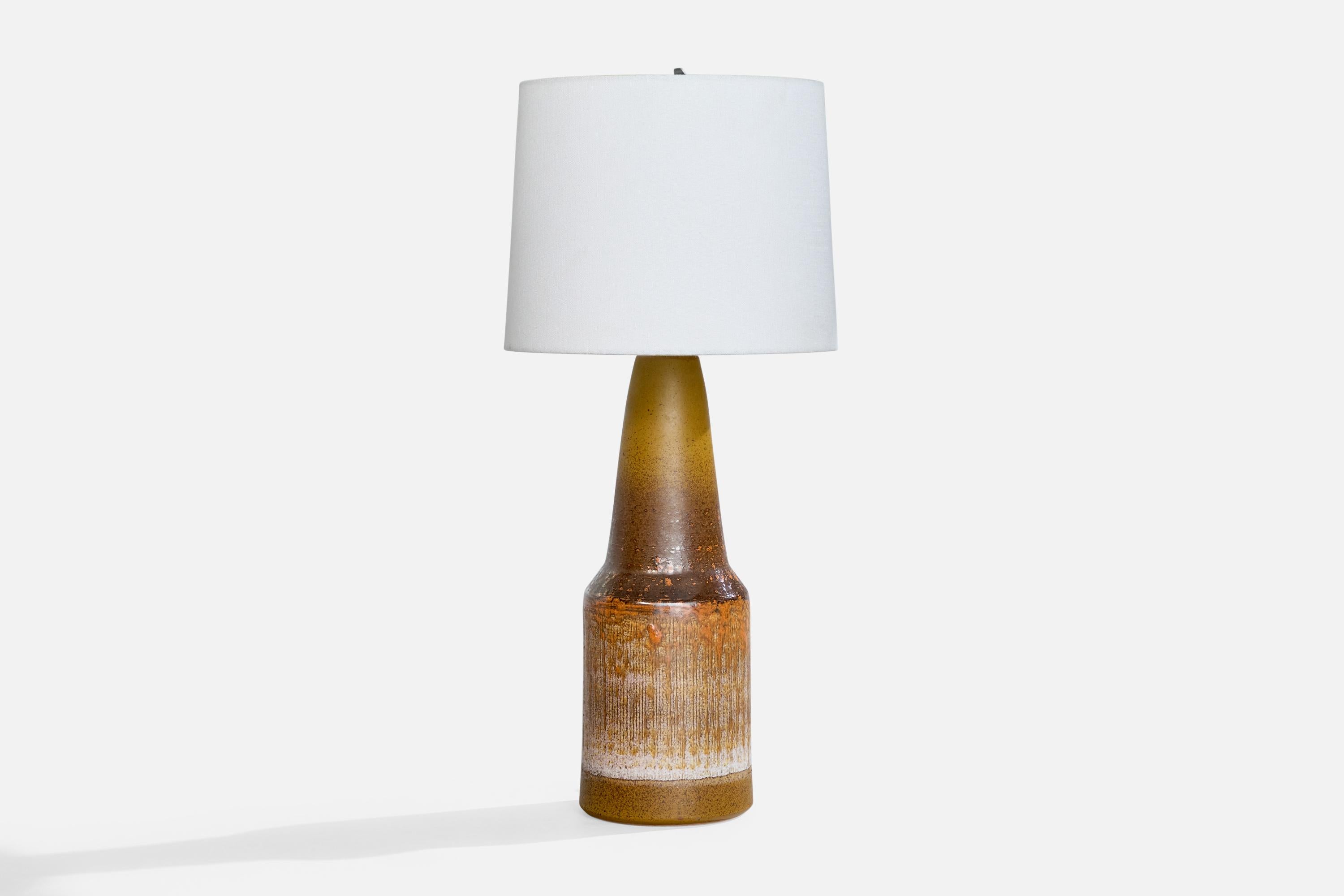 A glazed ceramic table lamp produced by Tilgmans Keramik, Sweden, c. 1960s.

Dimensions of Lamp (inches): 16.25” H x 5.325” Diameter

Dimensions of Shade (inches): 9” Top Diameter x 10” Bottom Diameter x 8” H

Dimensions of Lamp with Shade (inches):