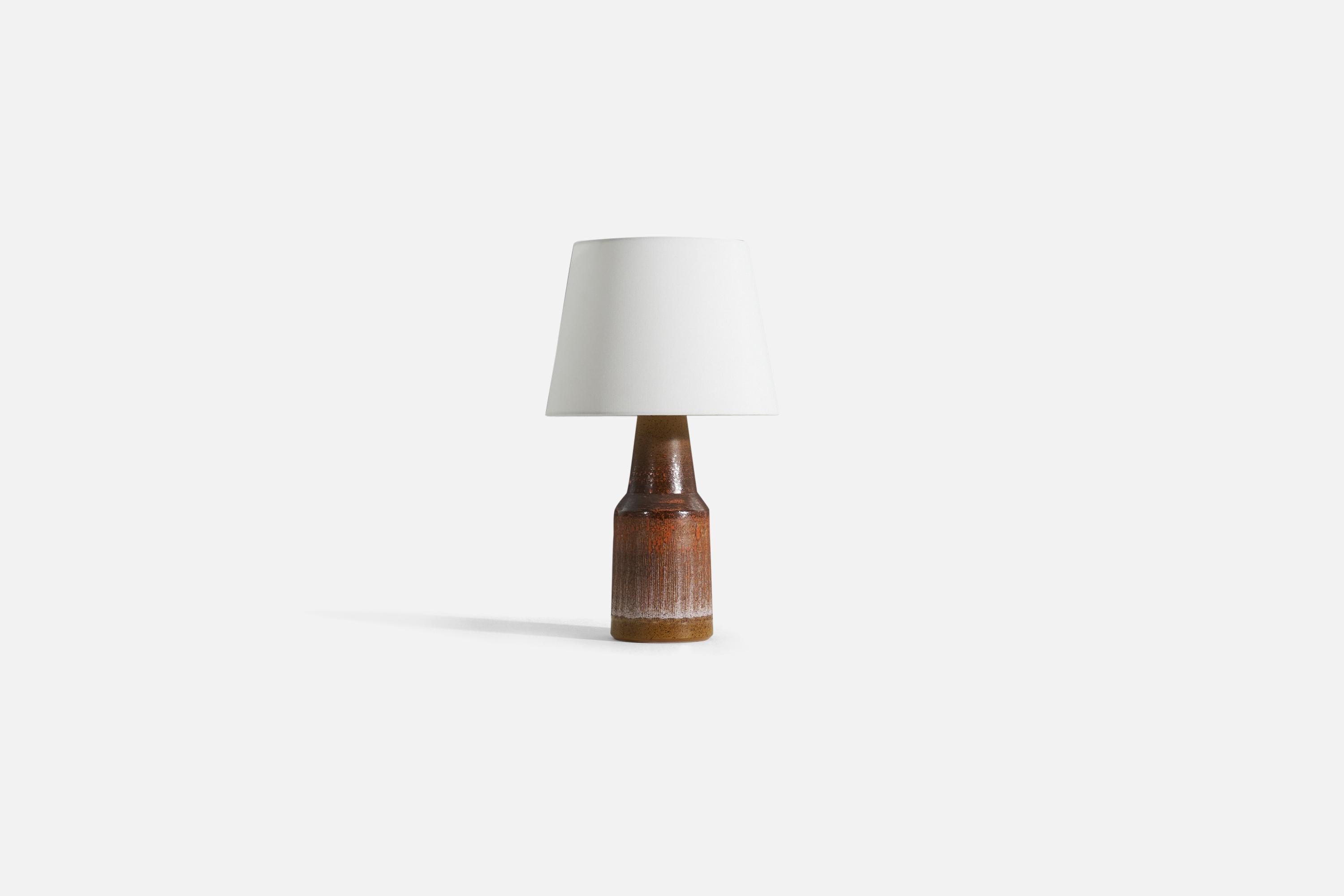 A glazed stoneware table lamp by Tilgmans Keramik, 1950s. Features a complex glaze combined with incised decor in a style iconic to the producer. 

Sold without lampshade. 
Dimensions of Lamp (inches) : 16.5 x 5.5 x 5.5 (H x W x D)
Dimensions of