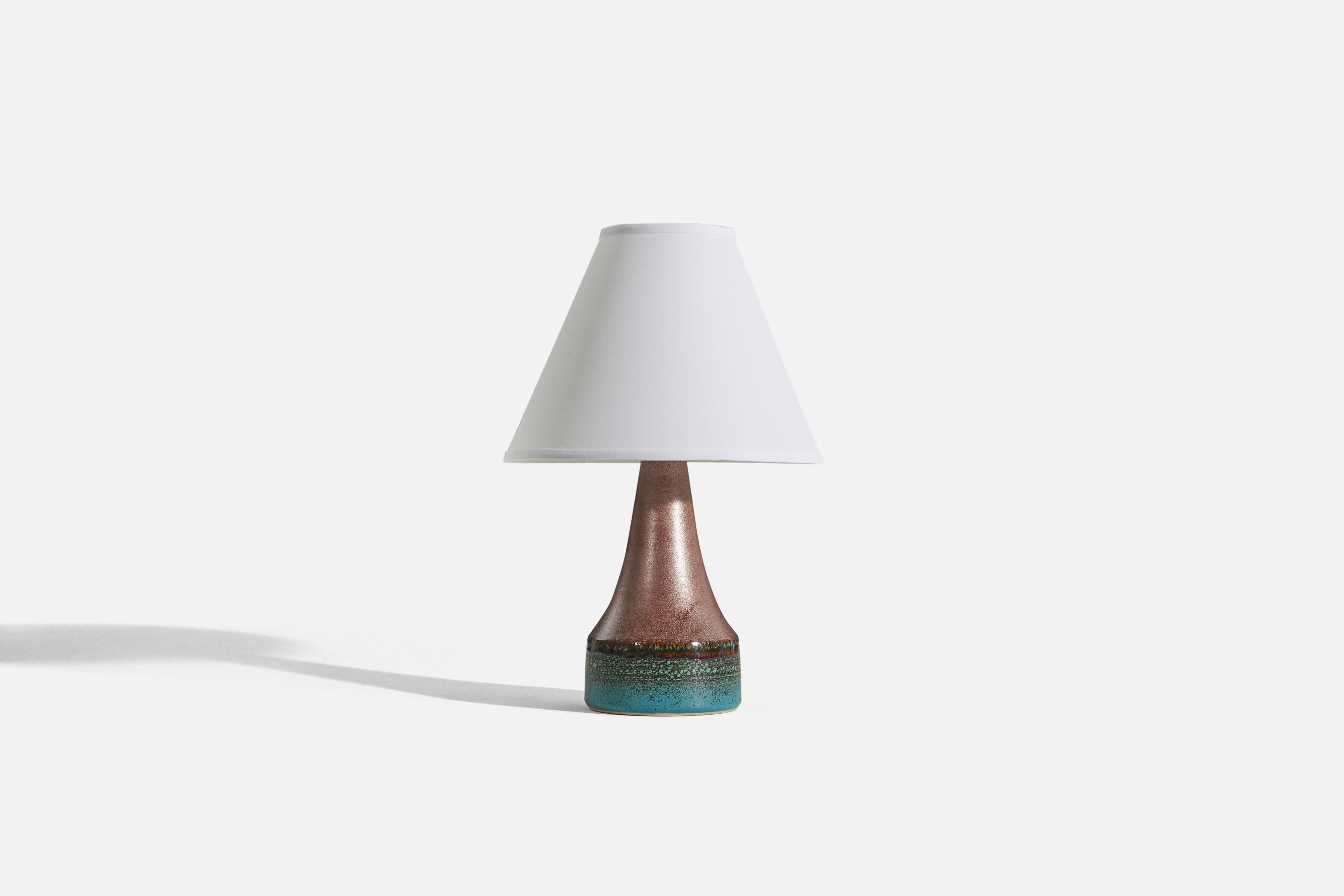 A brown and blue-glazed stoneware table lamp designed and produced by Tilgmans Keramik, Sweden, 1960s. 

Sold without lampshade. 
Dimensions of Lamp (inches) : 10.875 x 5 x 5 (H x W x D)
Dimensions of Shade (inches) : 4 x 10 x 8 (T x B x