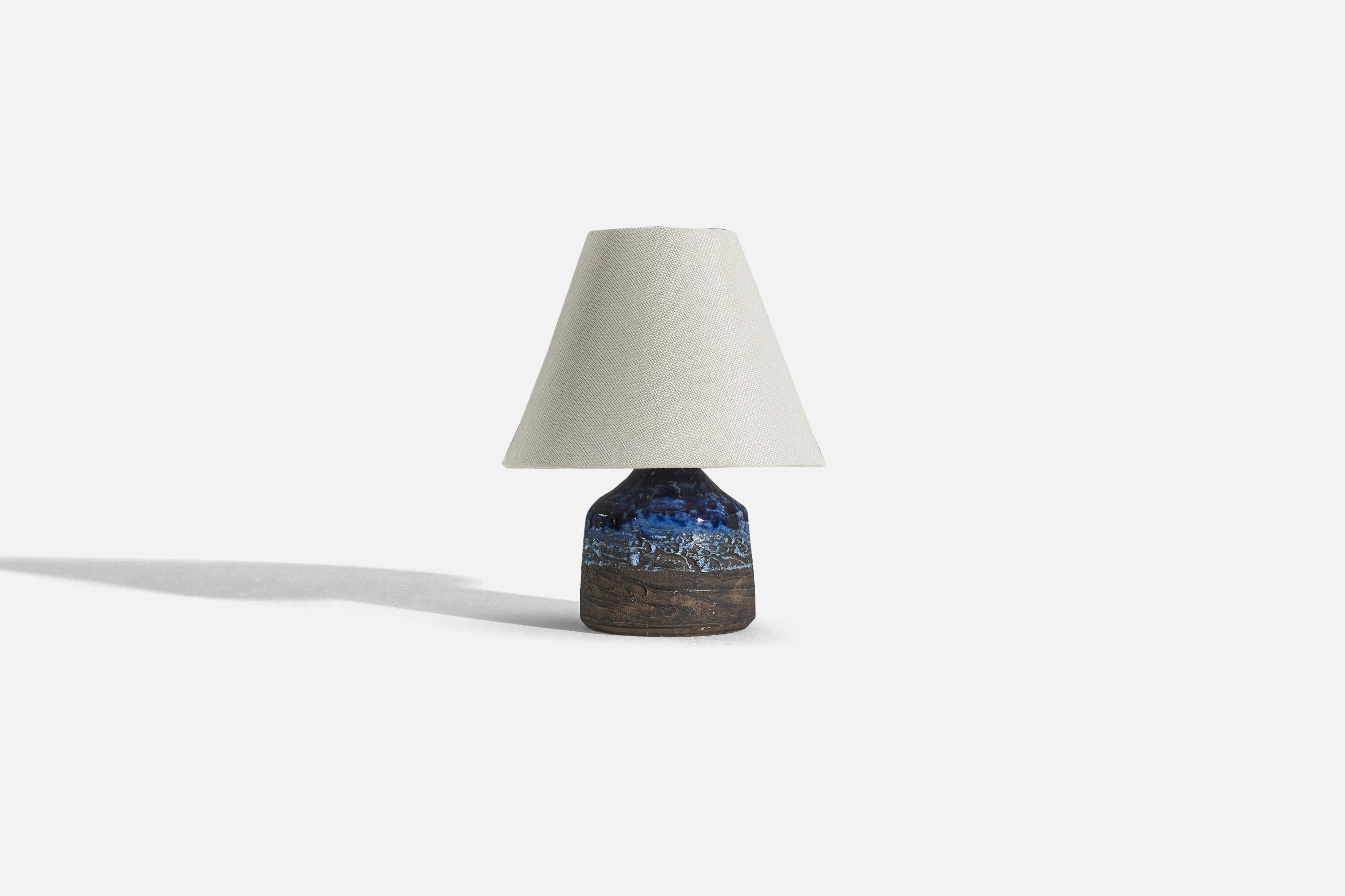 A brown and blue-glazed stoneware table lamp designed and produced by Tilgmans Keramik, Sweden, 1960s. 

Sold without lampshade. 
Dimensions of Lamp (inches) : 6.625 x 4.375 x 4.375 (H x W x D)
Dimensions of Shade (inches) : 3.75 x 8 x 6.25 (T x