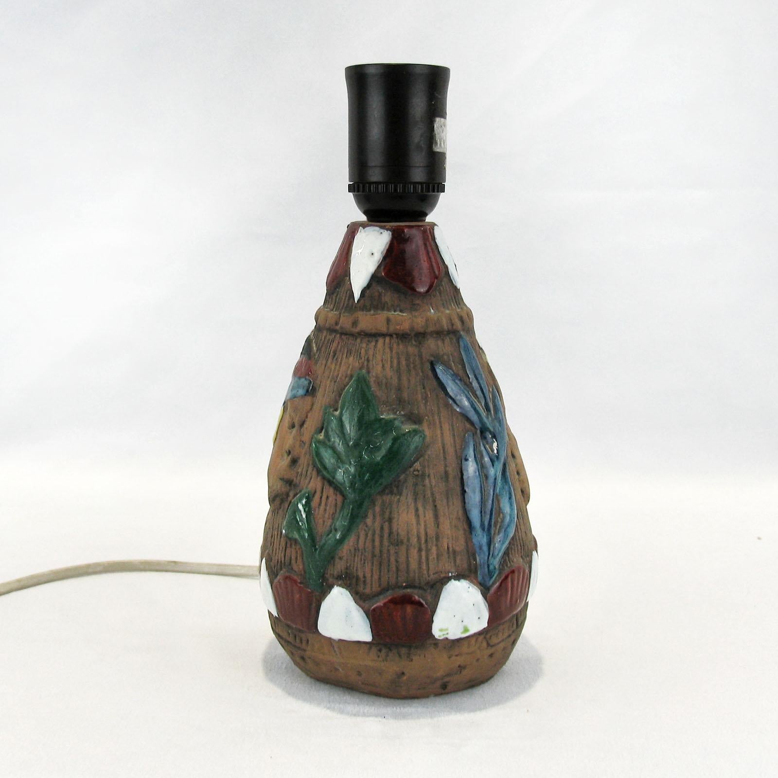 Exceptional earthenware table lamp made by Tilgmans Keramik, Sweden, early 1950s. Foot lamp decorated with an African couple, a boy and a girl, face to face, realized in sgraffito technique, details enhanced with colored over-glaze. Illuminated by