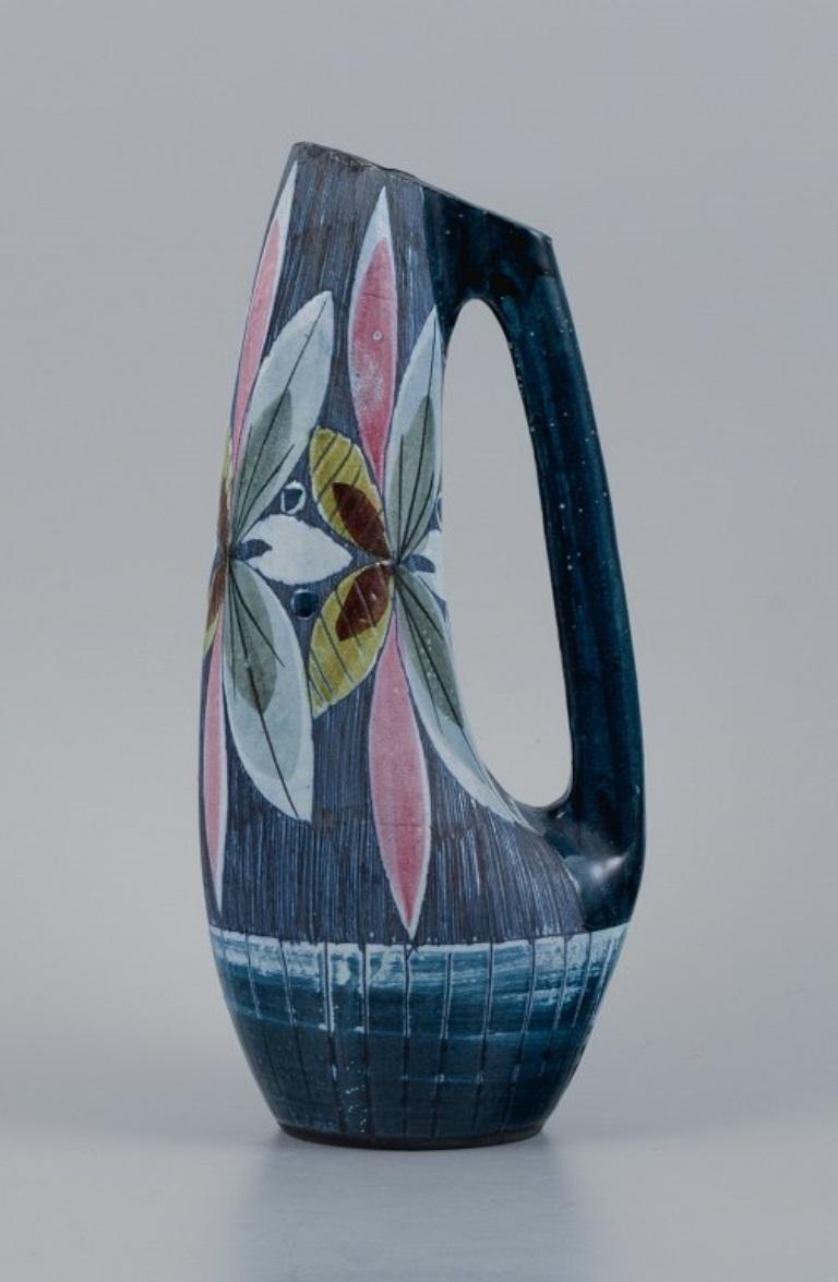 Tilgmans, Sweden, handmade retro ceramic jug with floral motifs.
1970s.
Perfect condition.
Marked.
Dimensions: H 24.8 x D 12.0 cm.
