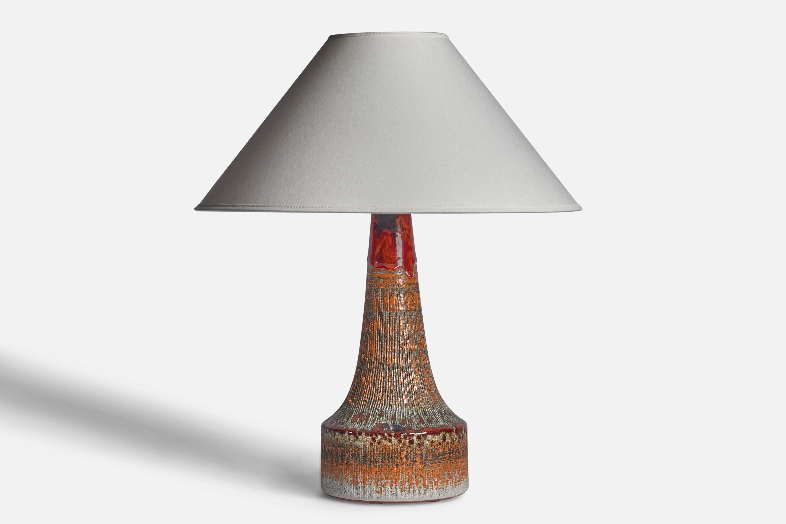 An orange, red and grey-glazed stoneware table lamp designed and produced by Tilgmans, Sweden, c. 1950s.

“Tilgmans Sweden” stamp on bottom.

Dimensions of Lamp (inches): 14.5” H x 6.5” Diameter
Dimensions of Shade (inches): 4.5” Top Diameter x