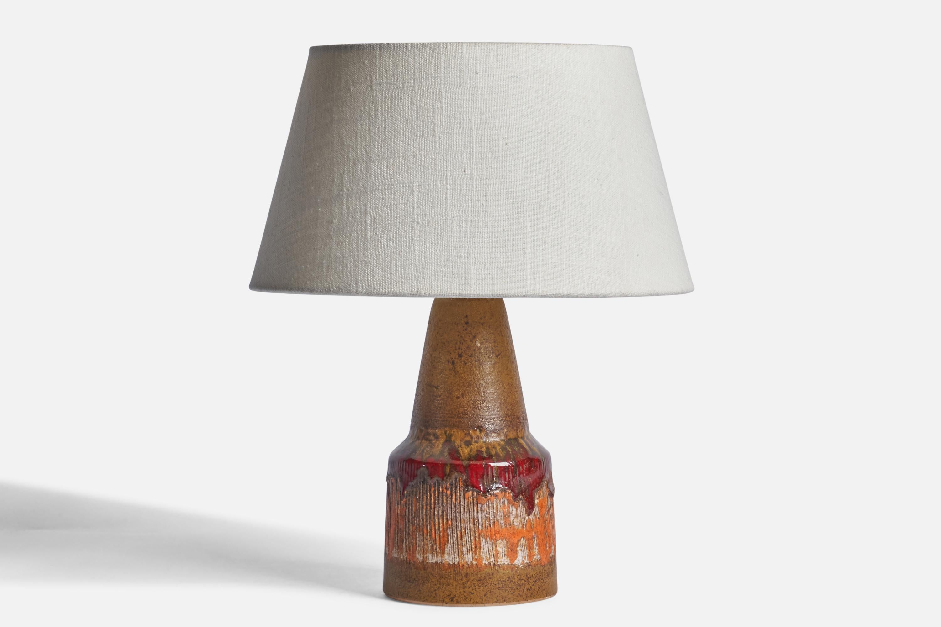 A brown, red and orange-glazed stoneware table lamp designed and produced by Tilgmans Keramik, Sweden, c. 1960s.

Dimensions of Lamp (inches): 9.25” H x 4” Diameter
Dimensions of Shade (inches): 2.5” Top Diameter x 10” Bottom Diameter x