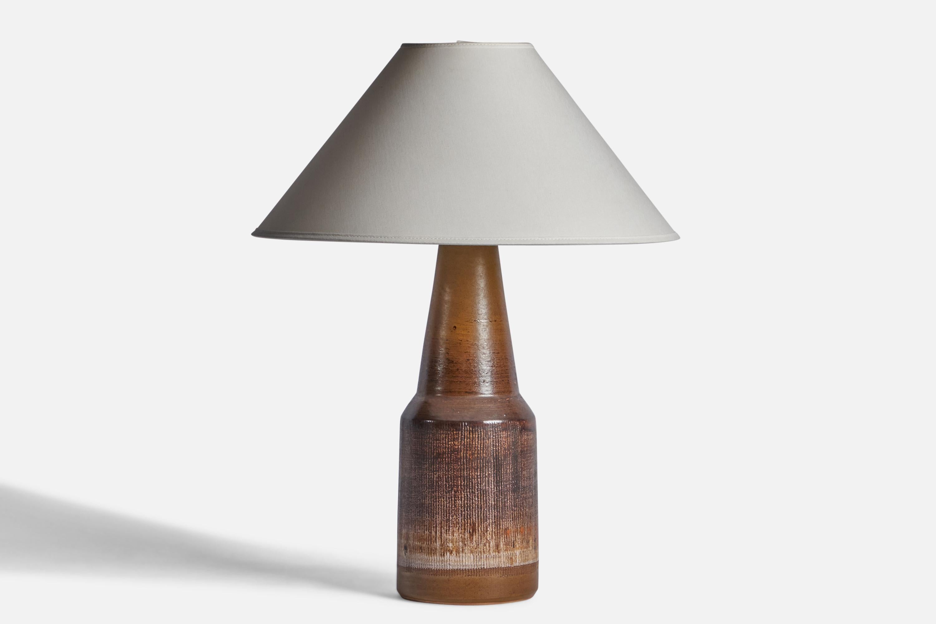 A brown-glazed stoneware table lamp designed and produced by Tilgmans Keramik, Sweden, 1960s.

Dimensions of Lamp (inches): 16.5” H x 5.25” Diameter
Dimensions of Shade (inches): 4.5” Top Diameter x 16” Bottom Diameter x 7.25” H
Dimensions of Lamp