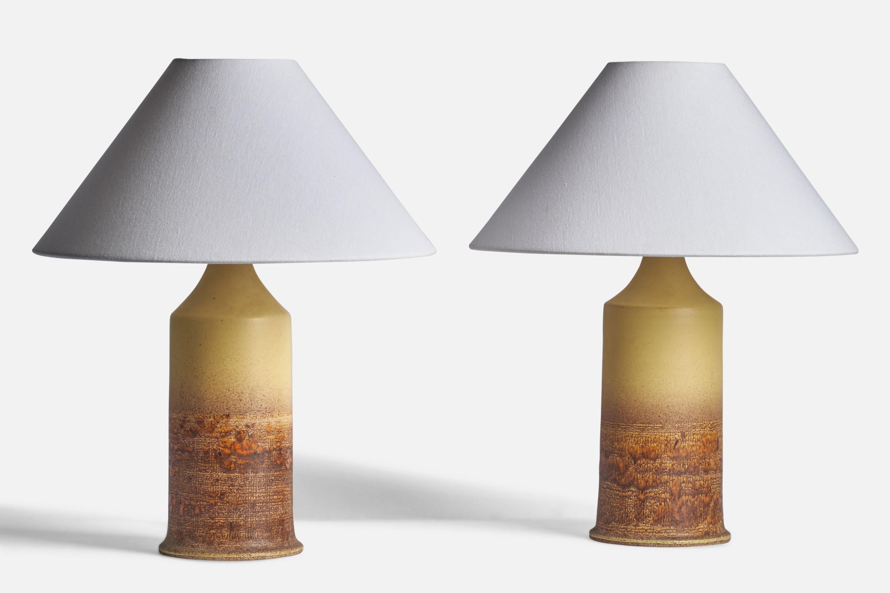 A pair of yellow and brown-glazed stoneware table lamps designed and produced by Tilgmans Keramik, Sweden, c. 1960s.

Dimensions of Lamp (inches): 14.5” H x 5.6” Diameter
Dimensions of Shade (inches): 4.5” Top Diameter x 15.75” Bottom Diameter x