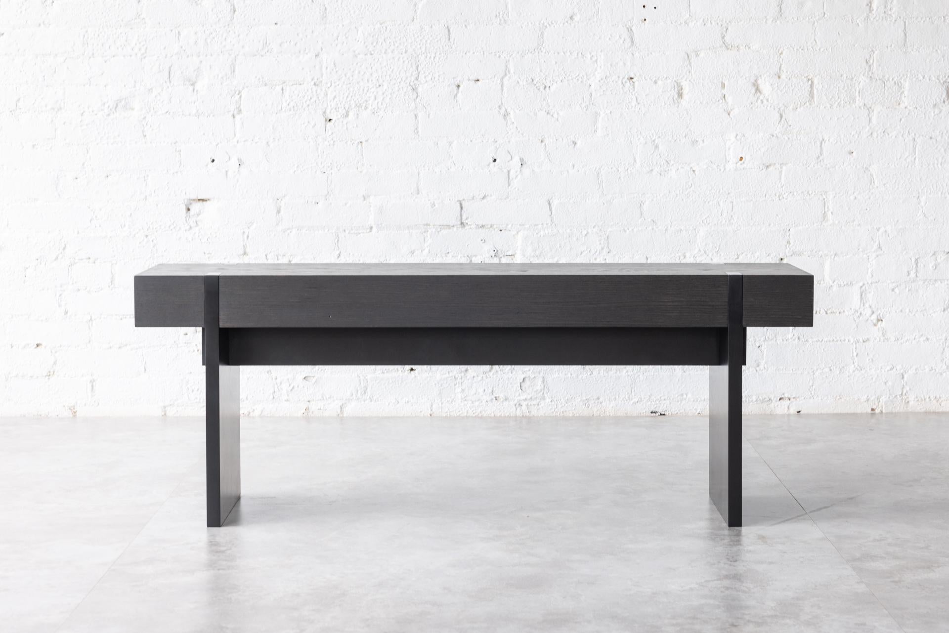The Tillikum bench in Blackened Oak is set on matte black frame and legs for a dramatic statement. The minimalist design by Kirk Van Ludwig combines these elements to create a modern entrance bench.

A tailored bench for contemporary design-driven