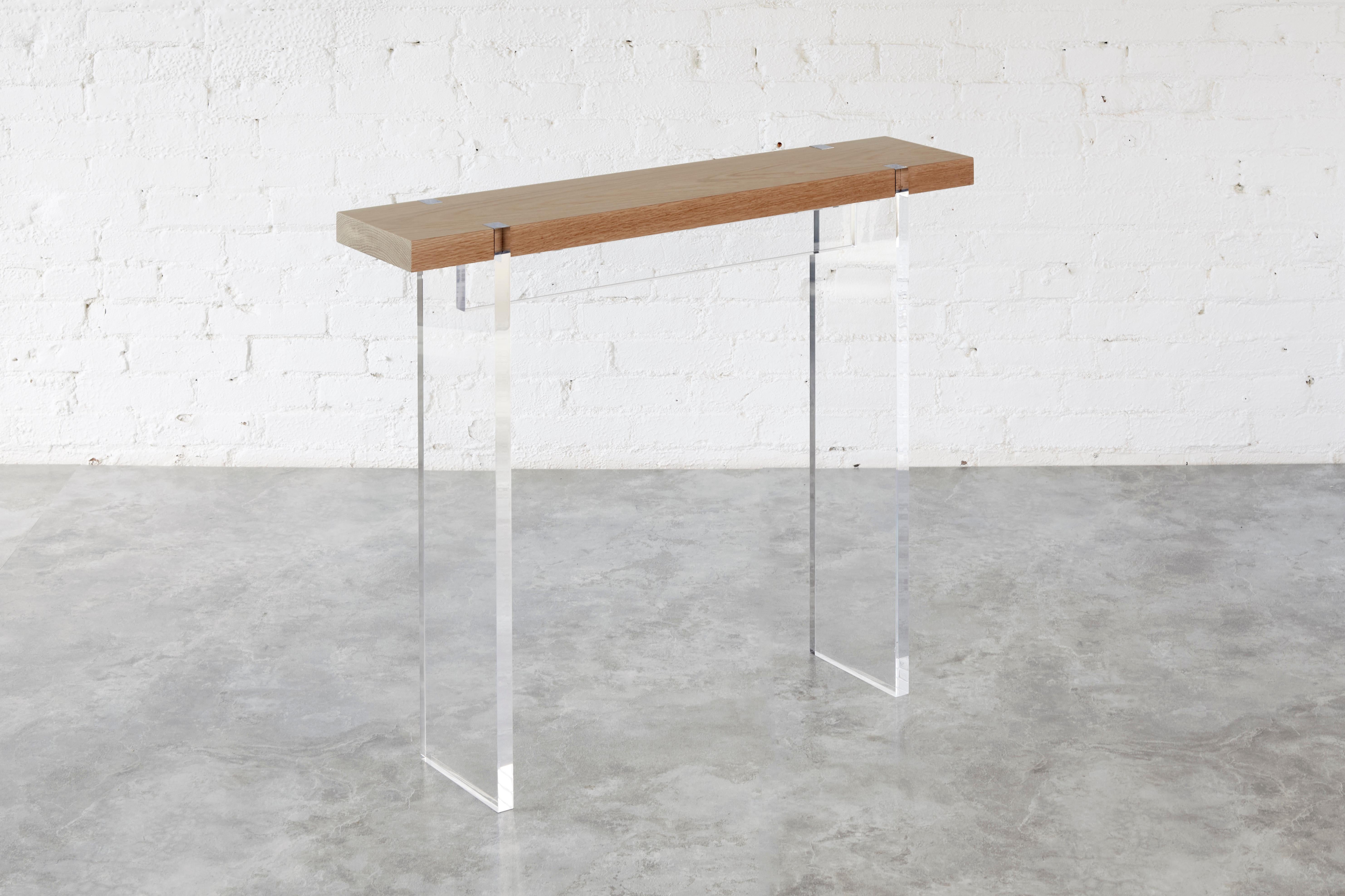 A tailored version of our original Tillikum Console, the Tillikum Narrow Console is a scaled down version to suit a smaller space. This stunning piece features a floating tabletop supported by sleek acrylic legs, creating a modern statement in any