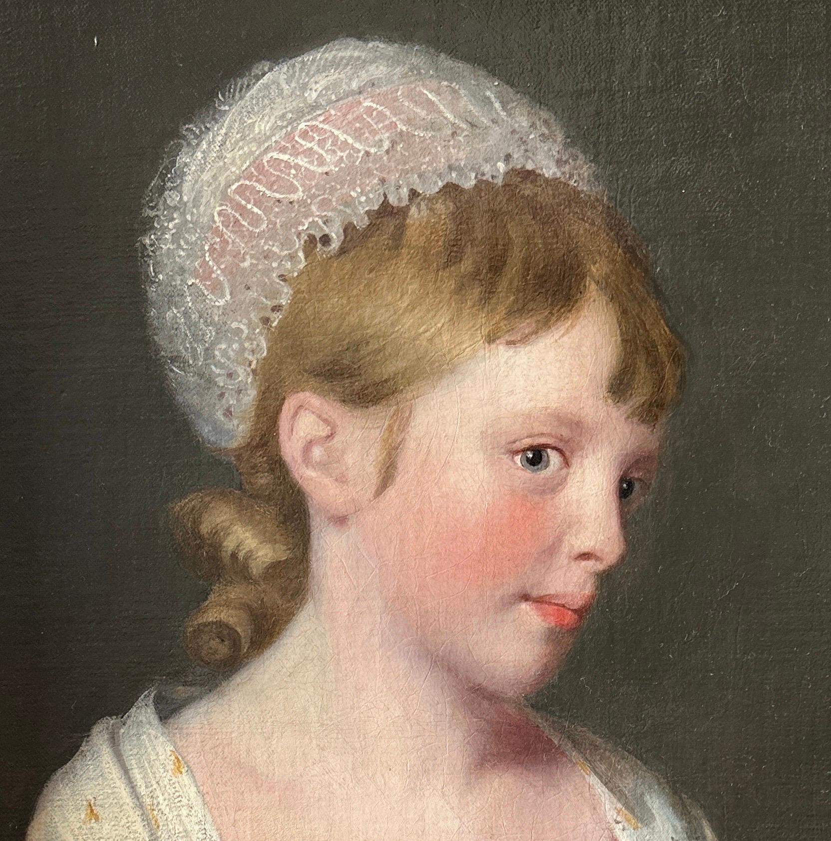 Porträt eines blonden jungen Mädchens in grünem Kleid, rosa-weißer Spitzenhaube und einem gemusterten Schal um die Schultern, möglicherweise mit indianischem Muster, das sich auf einen Steinsockel stützt. Öl auf Leinwand in einem Rahmen aus Goldholz