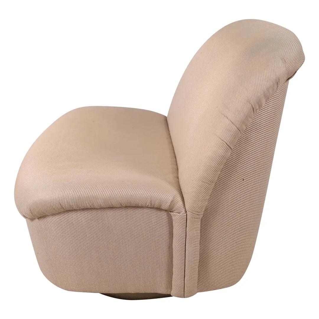 This sculptural chair by Vladimir Kagan for Directional has a slightly curved back and seat which tilts and swivels on an upholstered round base. 

About Vladimir Kagan 
A German born into a Russian cabinetmaking family, moved to New Jersey, USA
