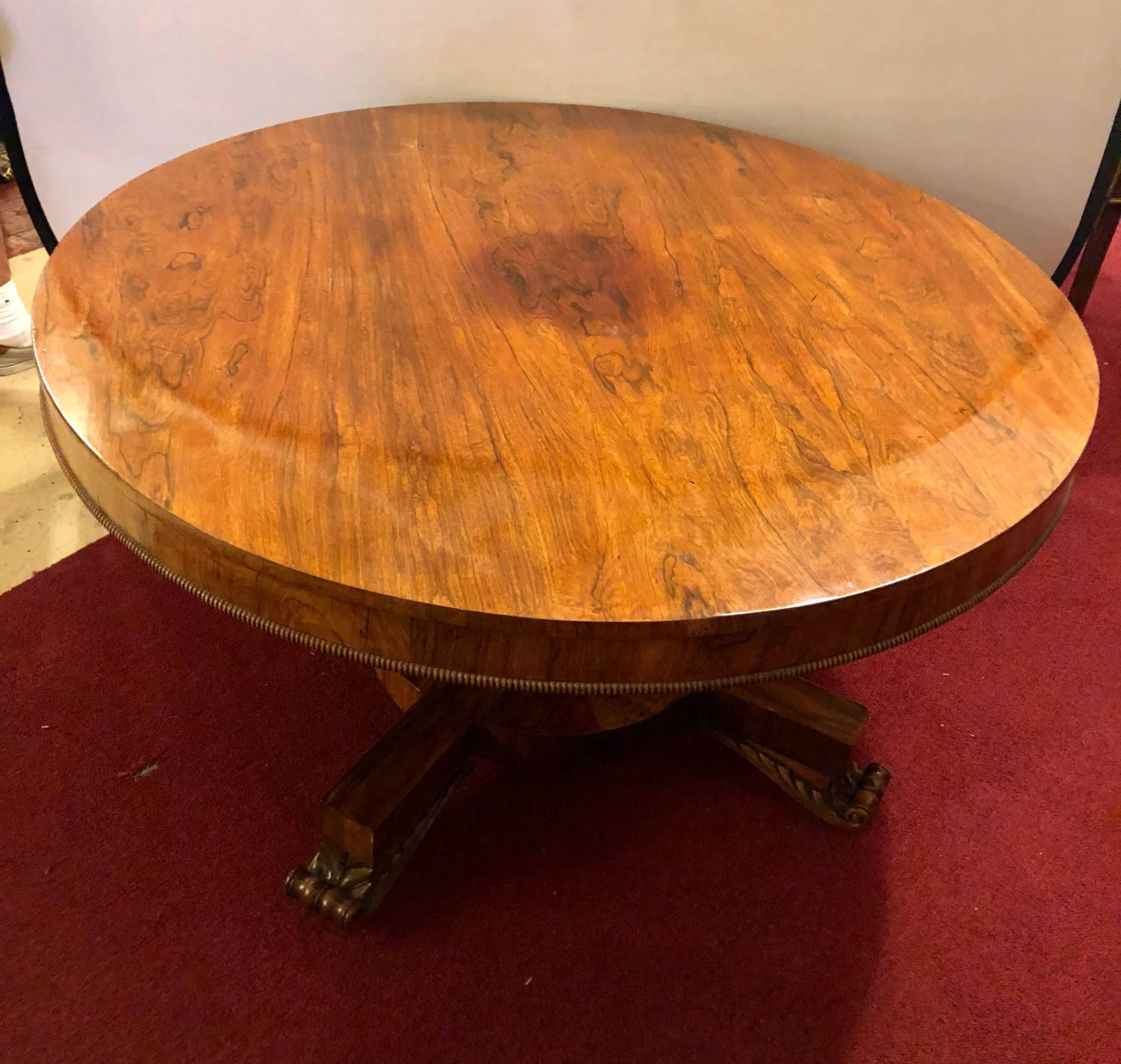 This 19th century tilt-top rosewood breakfast / centre table or dining table sits on claw feet with all original features. This antique rosewood centre, dining or breakfast table is in wonderful condition and comes to us fresh out of a Northern New