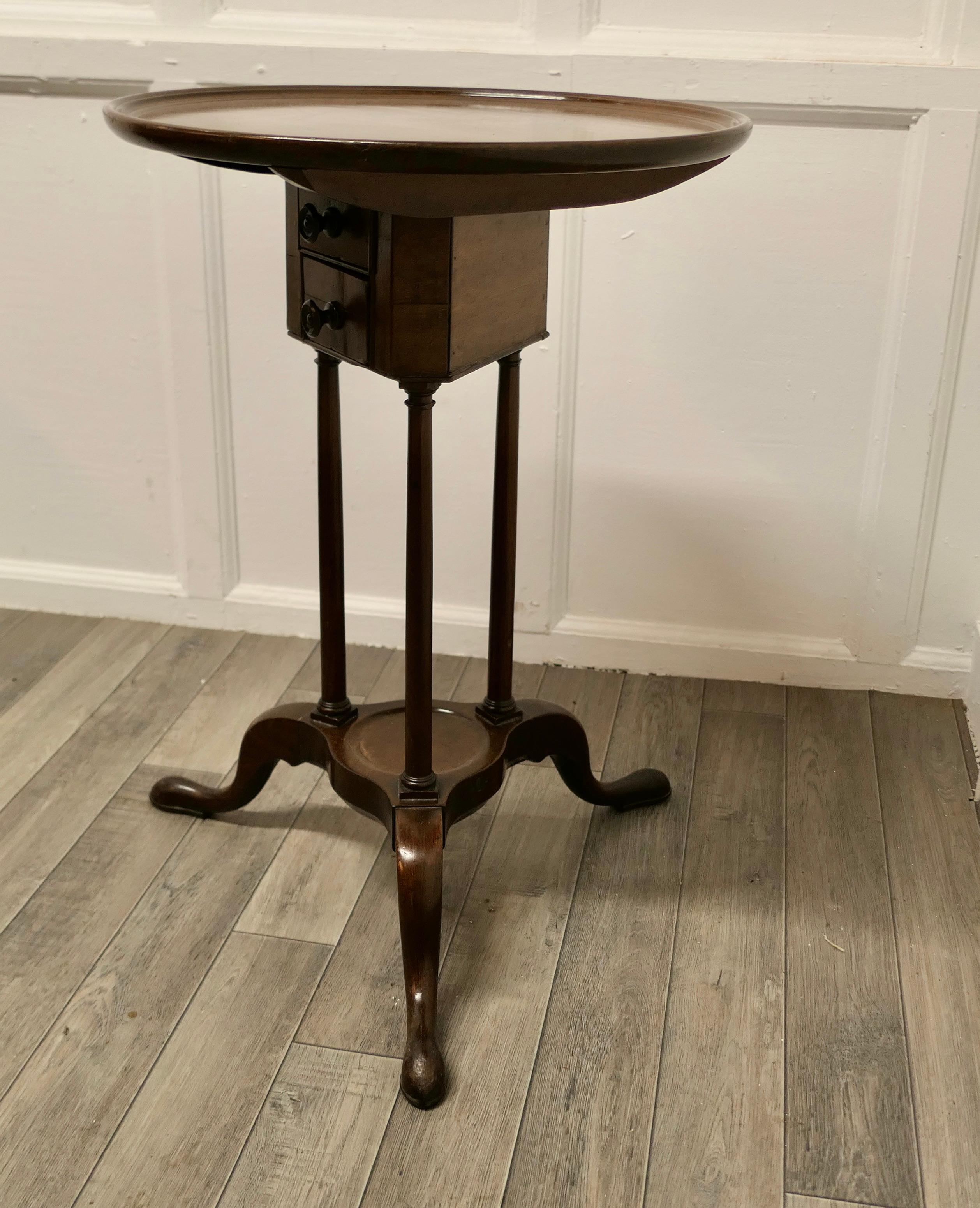 Tilt top wine table with drawers under

This lovely table stands on a three legged base with a small undertier, at the top there are 2 small drawers that can be accessed best when the table is tipped up

The circular top has a raised edge which