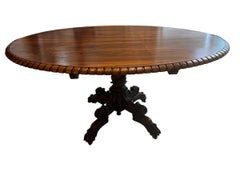 Mesa de centro o de desayuno anglo colonial ovalada de palisandro basculante con base tallada