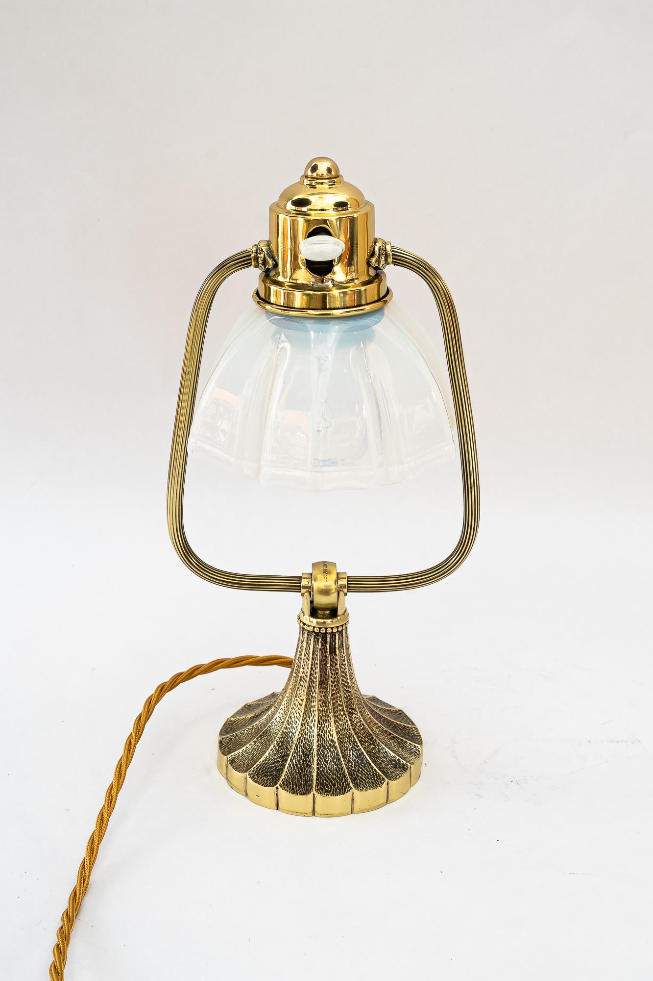 Tilting art deco table lamp with opaline glass shade vienna around 1920s
Brass polished and stove enameled
Original opaline glass shade
