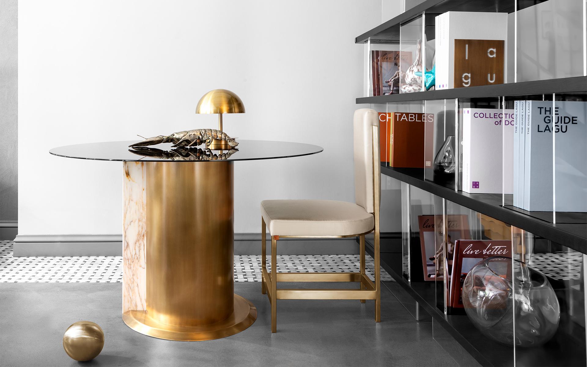 Get harmony in your home with TIM TABLE, which combines cirucular body, glass top, wood and metal details with different materials... 

Combining lagu's signature materials, brass and black glass, TIM TABLE creates an impact much larger than its