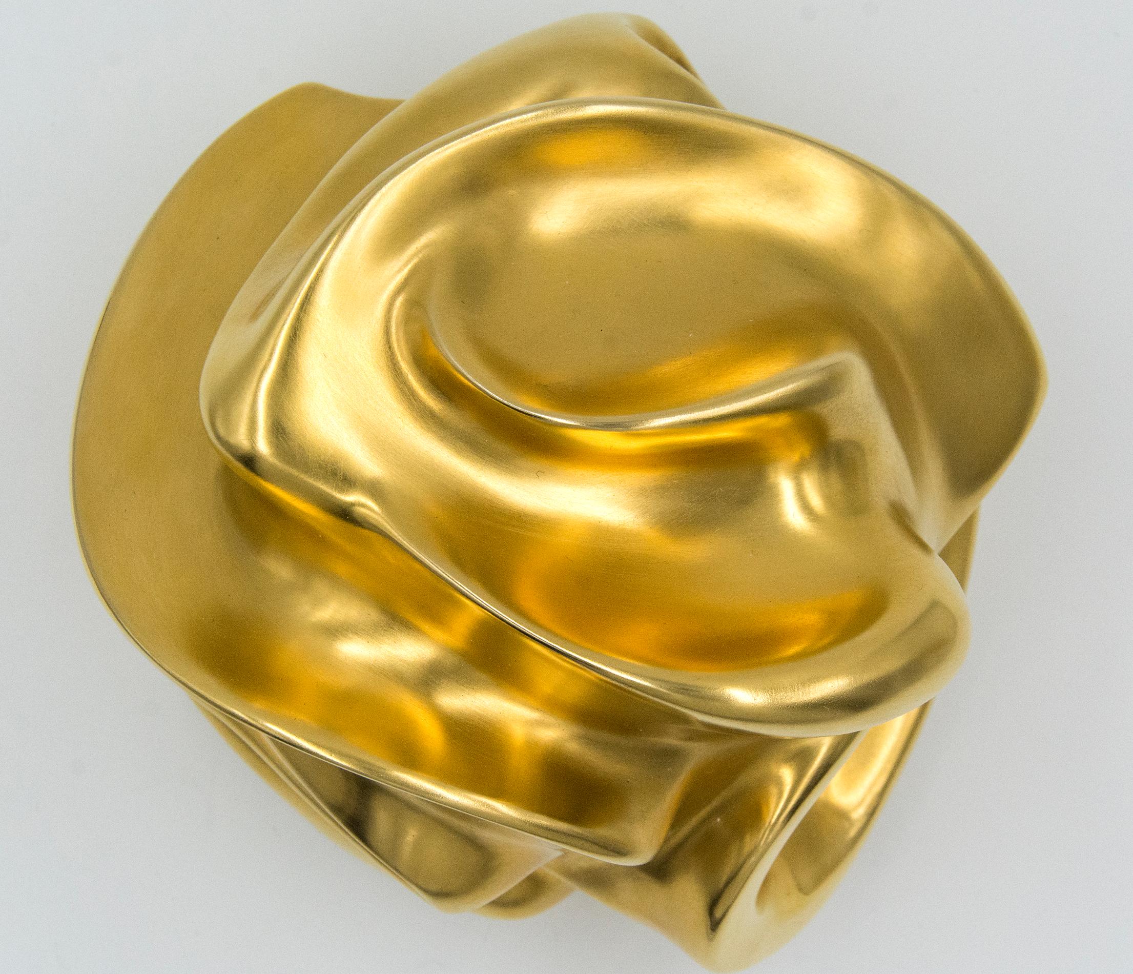 24K gold plated bronze takes an organic form that twists and breathes as it emerges from its base. The dynamic movement of this intimately sized sculpture by Tim Forbes is enhanced by its rich reflective surface. This work is the Artist's