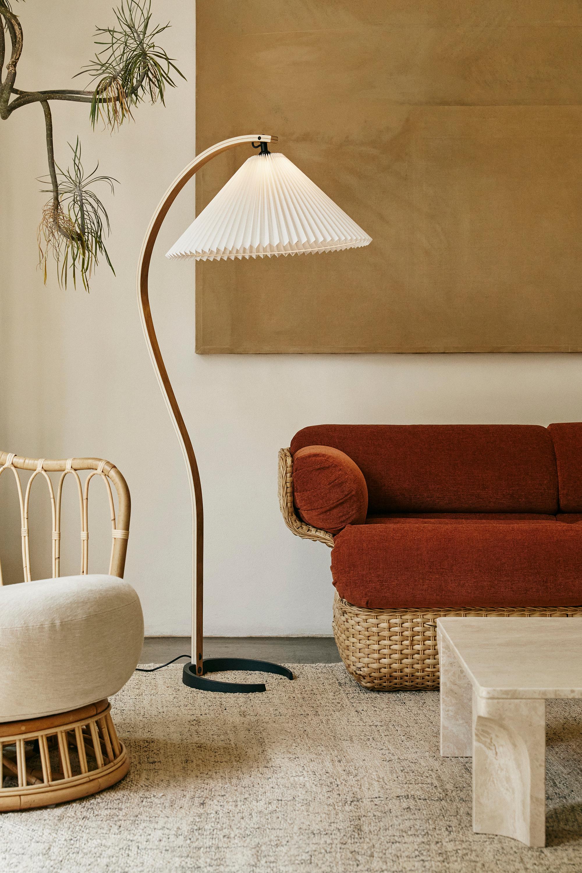 'Timberline' floor lamp for GUBI.

Originally designed by Mads Caprani in the 1970s, this authorized GUBI re-edition is executed in oak, birch, canvas on a cast-iron base. Like the original, the new Timberline balances form and function to provide